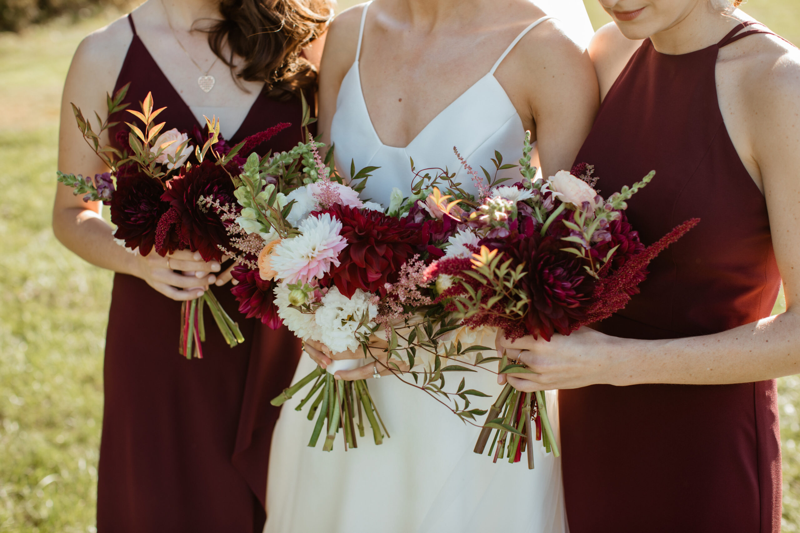 Bridesmaids burgundy bouquets at an Autumn Winery Wedding