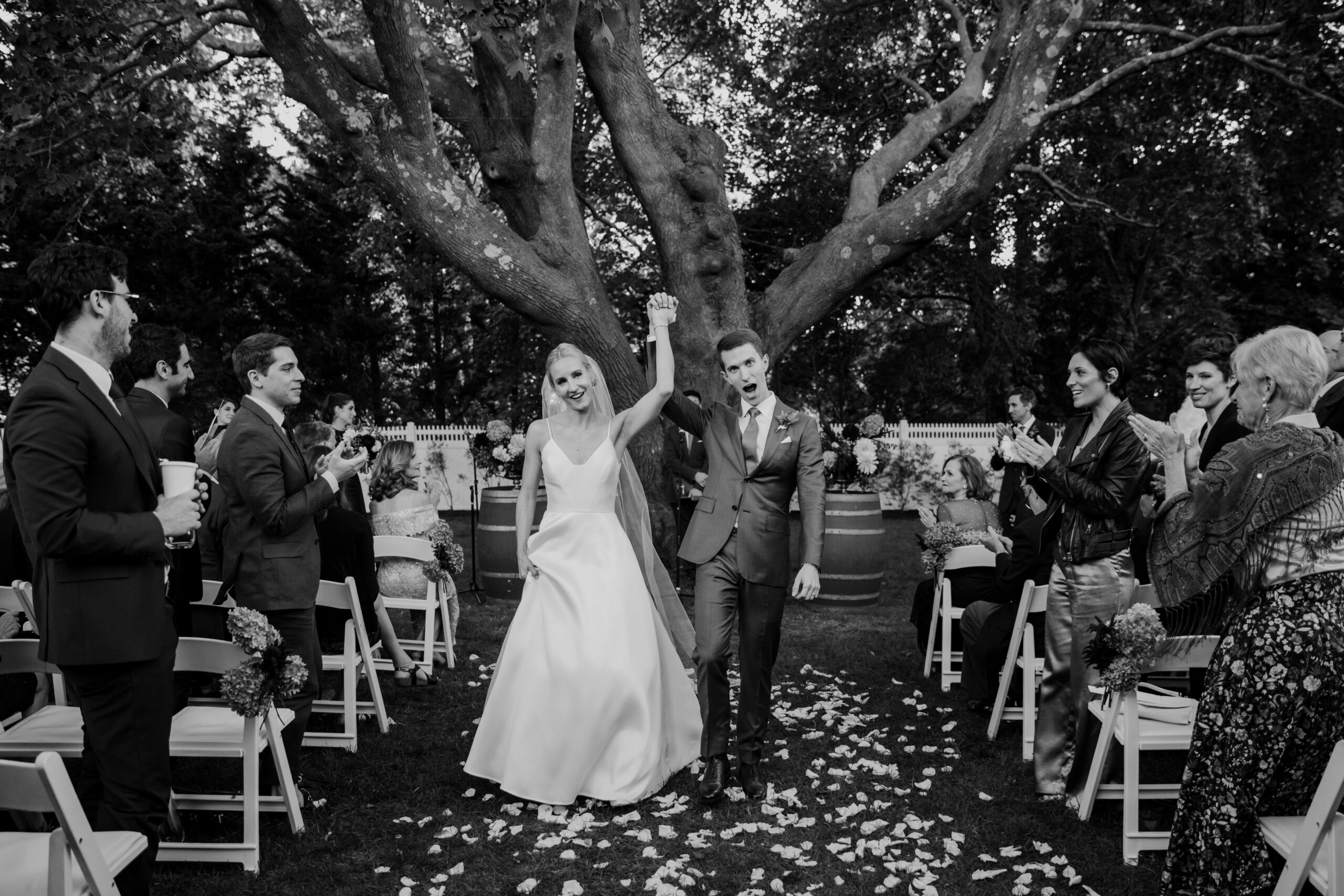 The wedding ceremony under a magnificent tree at Bedell Cellars