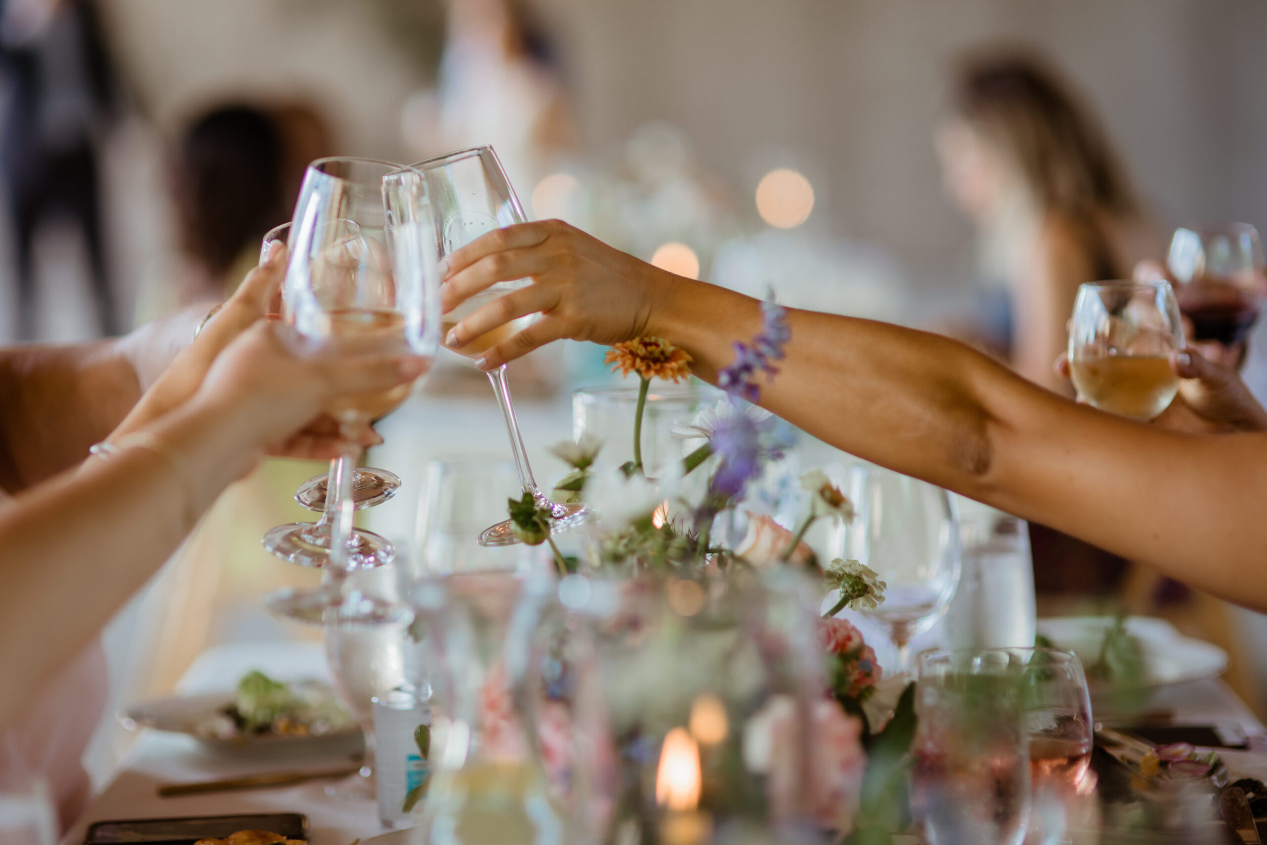 Guests toast over the wedding spread during their dreamy upstate New York wedding day! 