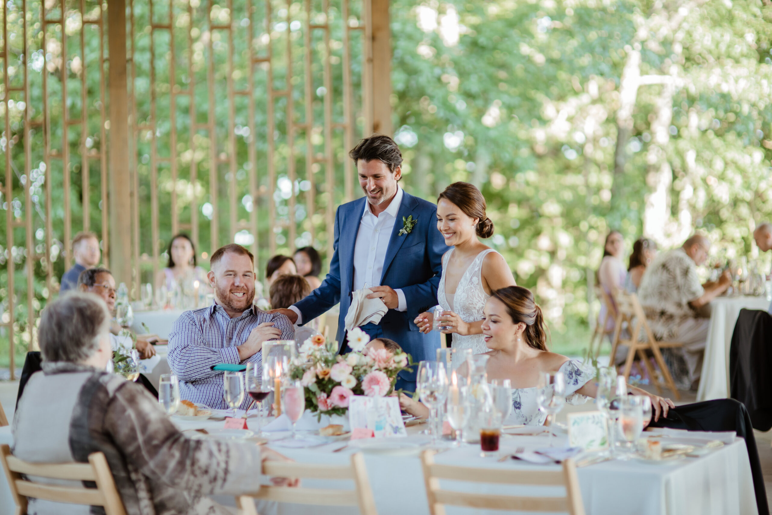 Stunning new bride and groom watch their guests celebrate during their modern Gather Greene wedding in Upstate New York
