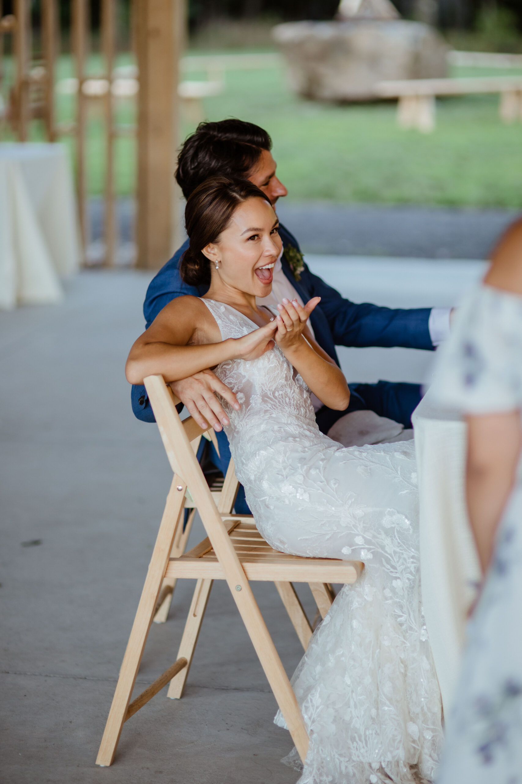 Stunning new bride and groom watch their guests celebrate during their modern Gather Greene wedding in Upstate New York