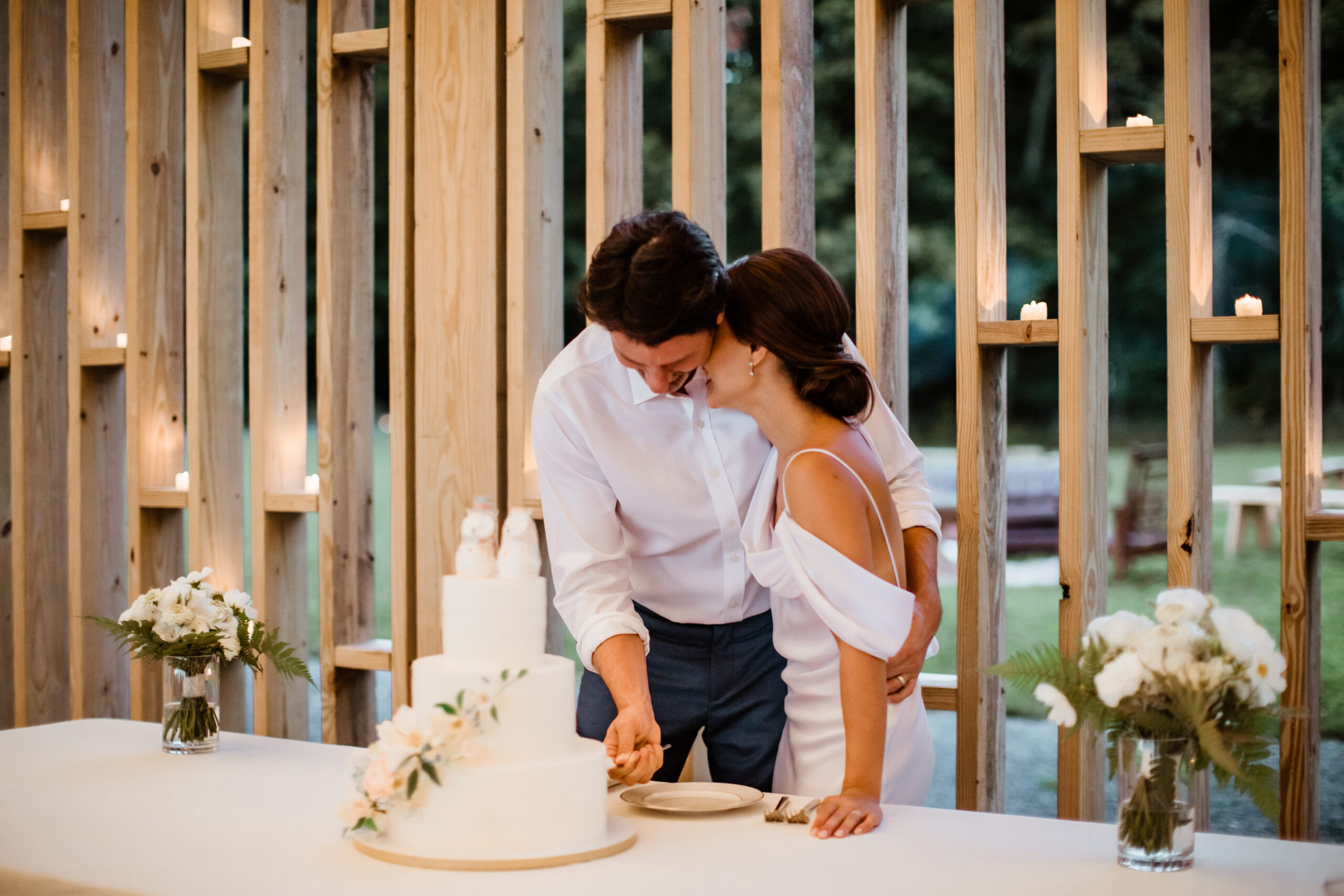 Stunning bride and groom cut their wedding cake on their dreamy upstate NY wedding day