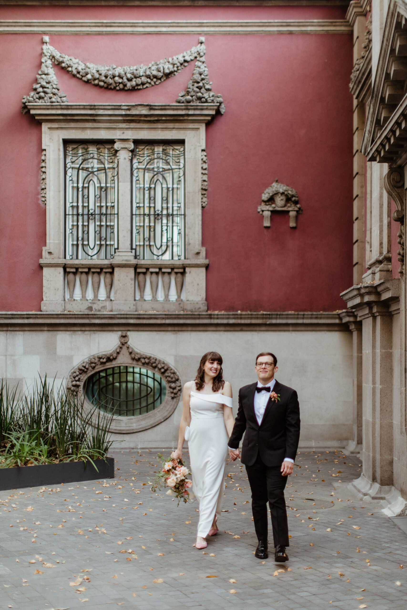 Beautiful bride and groom pose together downtown after their stunning Autumn elopement in Mexico City