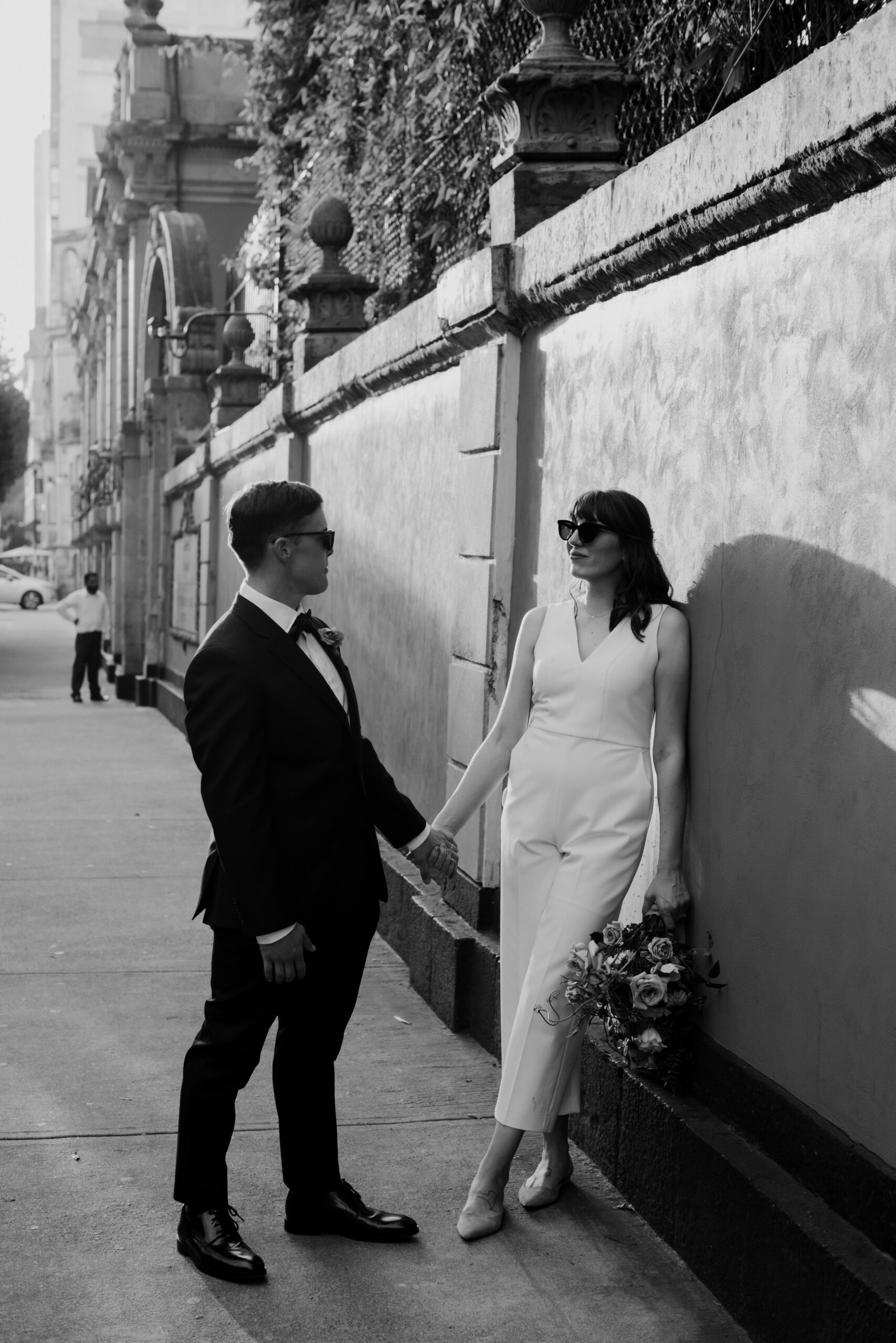 Stunning bride and groom pose together in the city