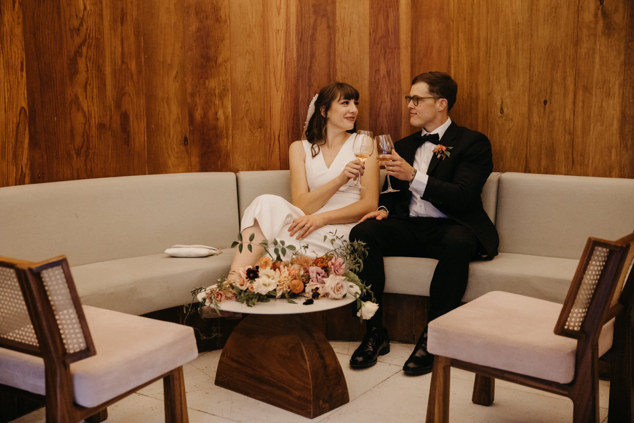Stunning bride and groom share champagne 