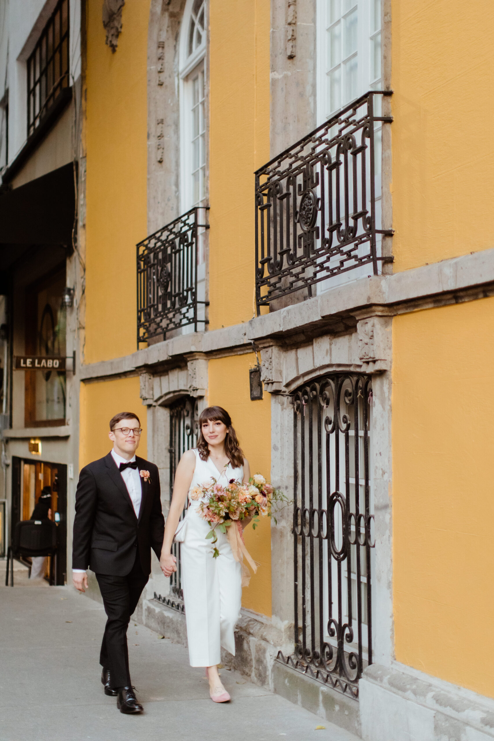 Stunning bride and groom pose together in the city