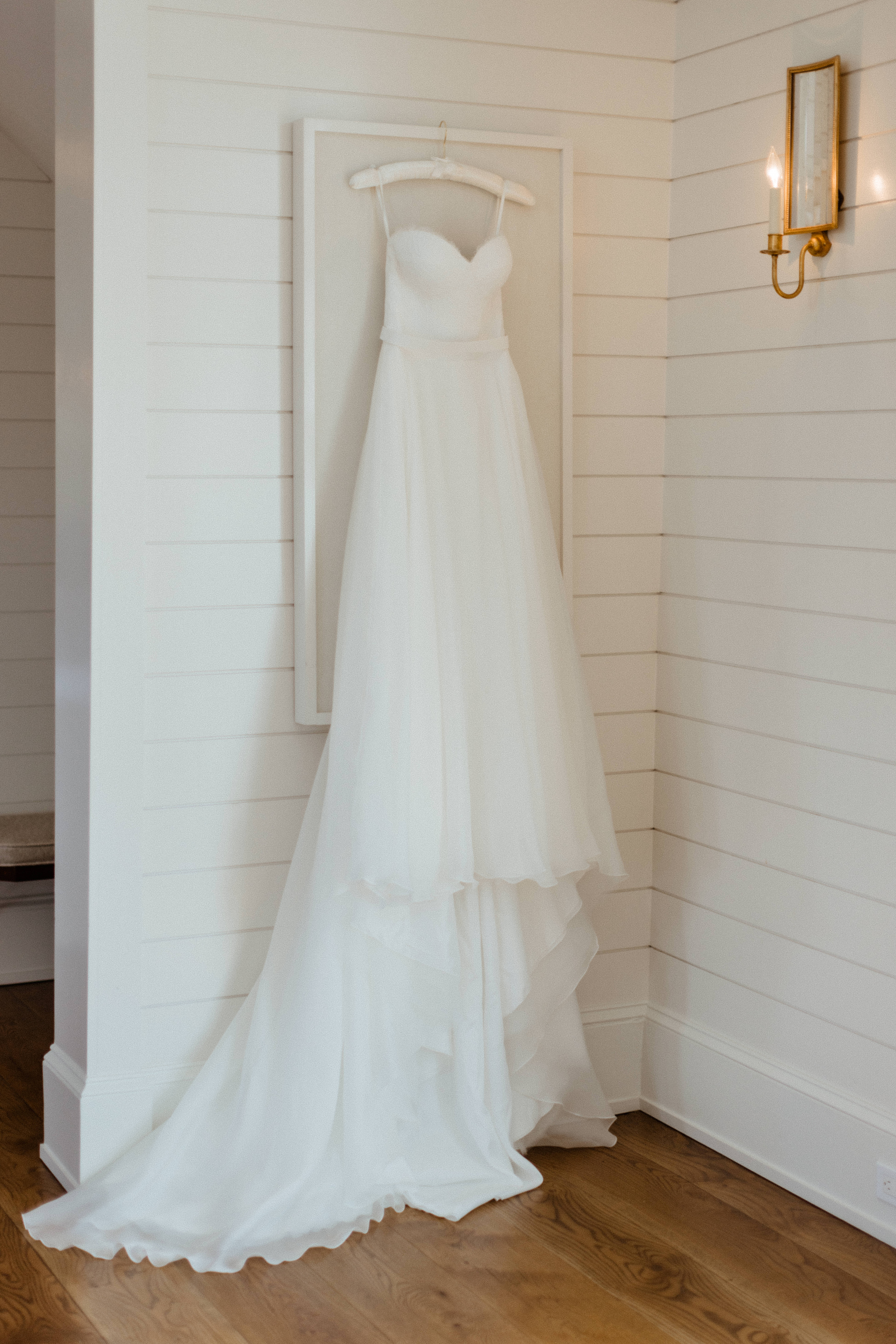 stunning wedding dress hangs ready for the big wedding day!