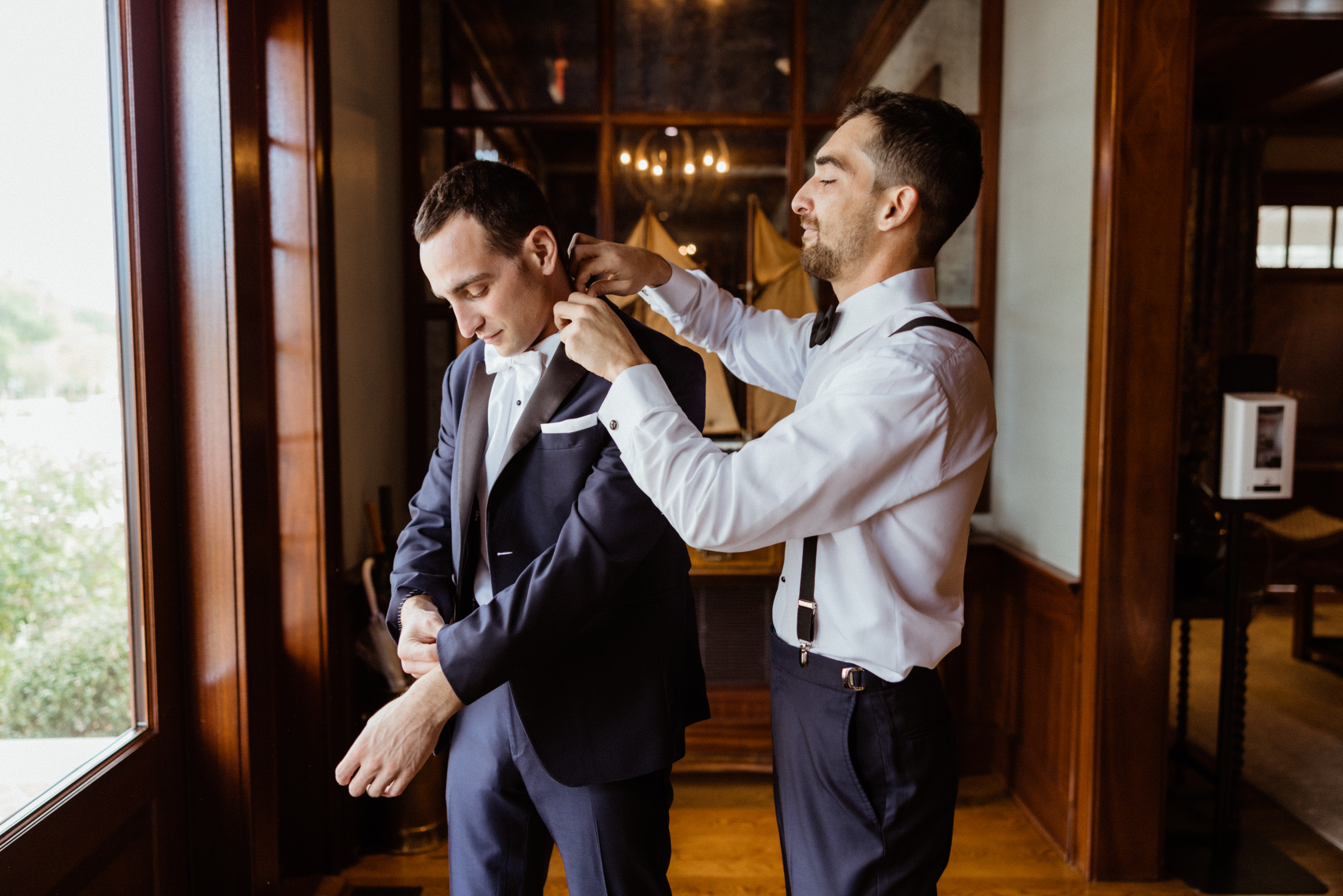 Groomsman helps groom add final touches as he prepares for his North East wedding day