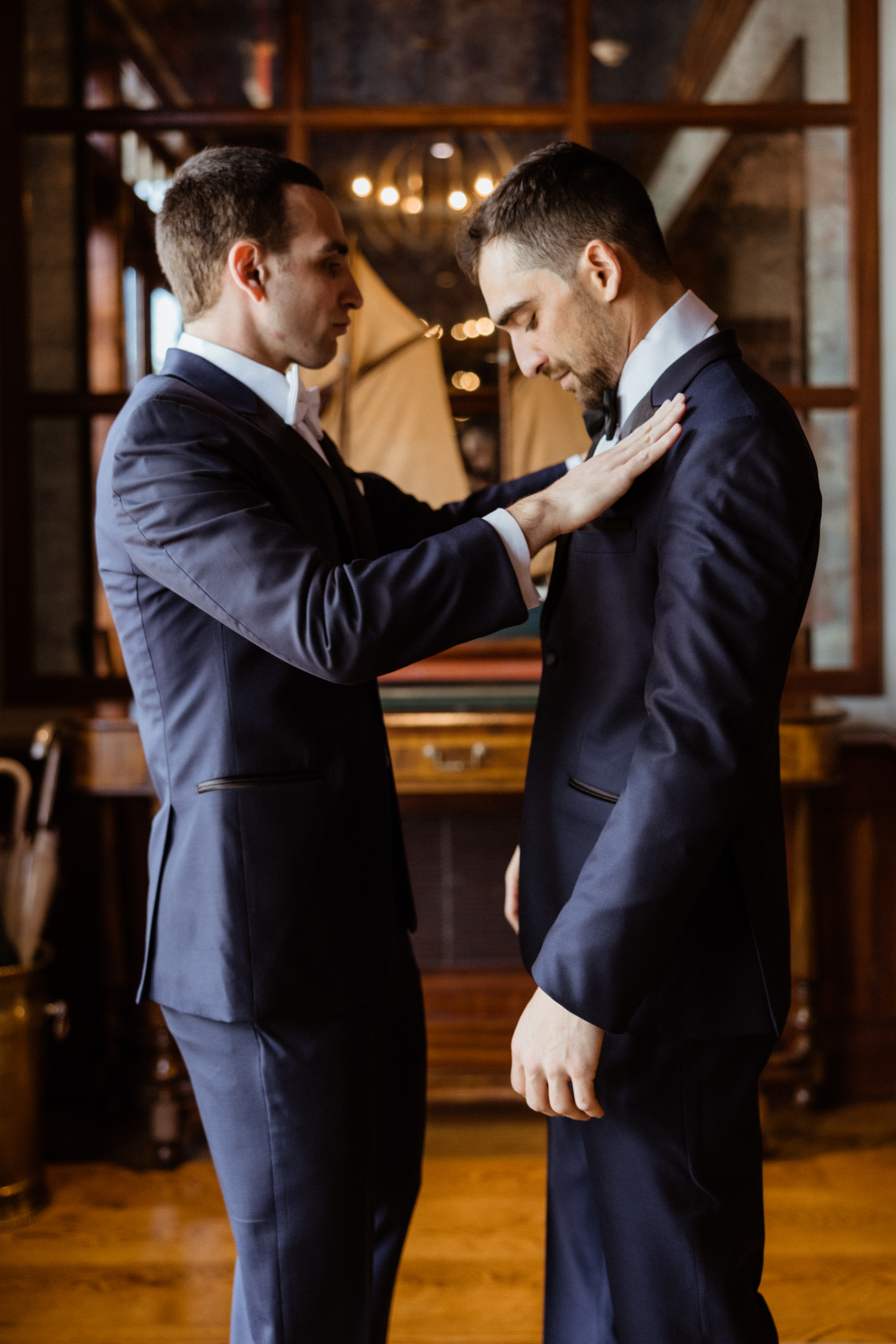 Groomsmen helps groom add final touches as he prepares for his north east wedding day