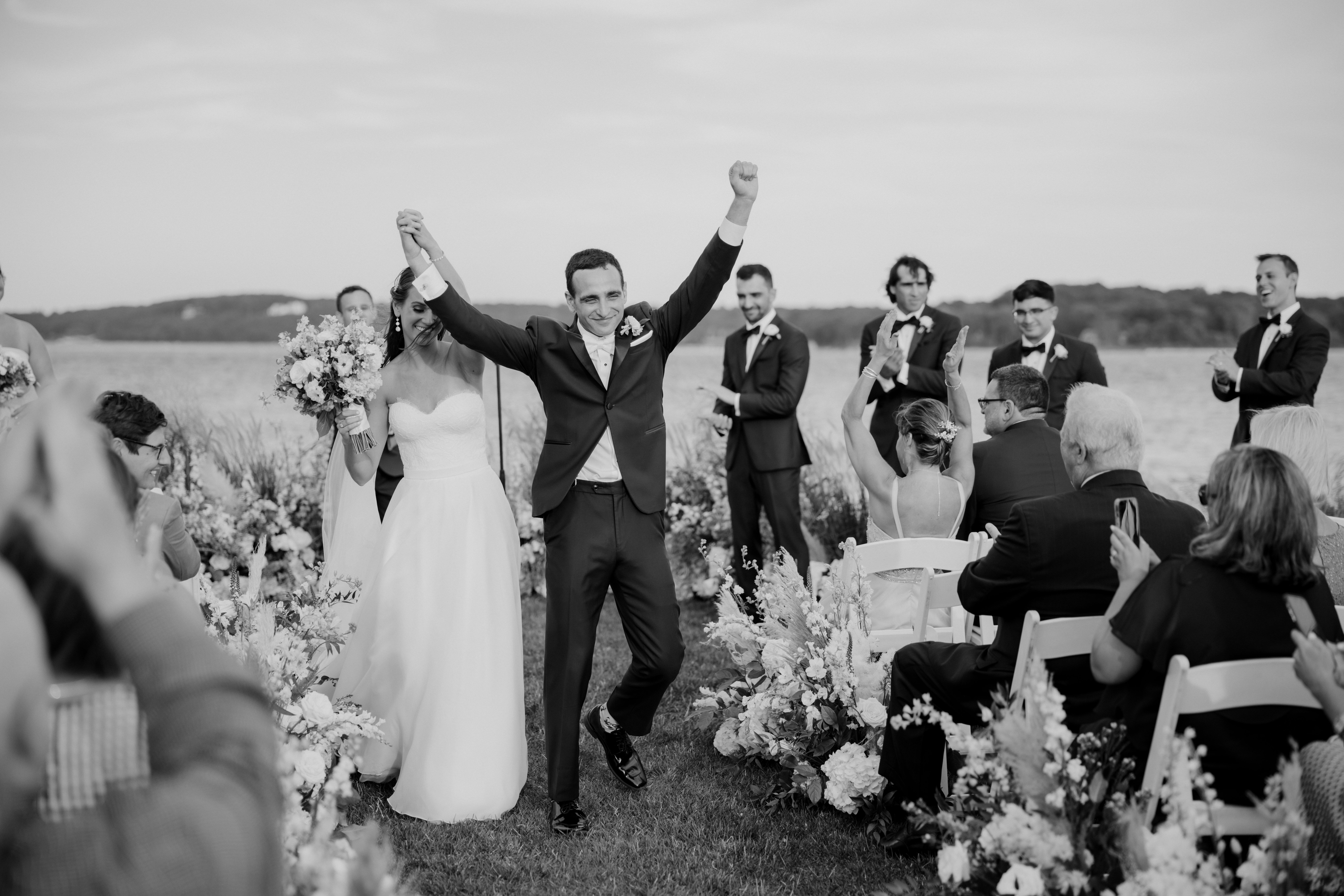 bride and groom celebrate as their dreamy northeast beach wedding ceremony ends