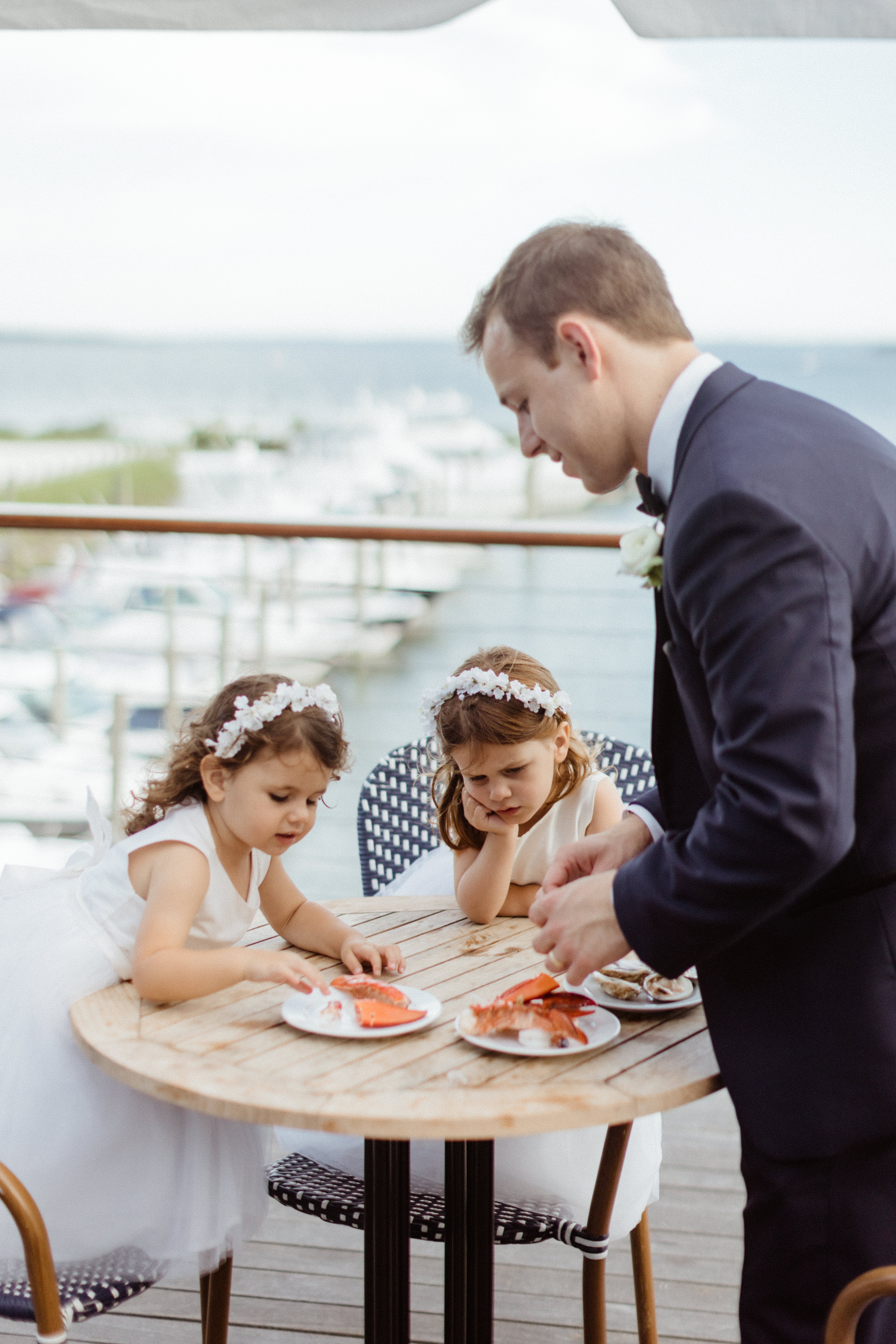 flower girls have a snack after their big north east beach wedding day