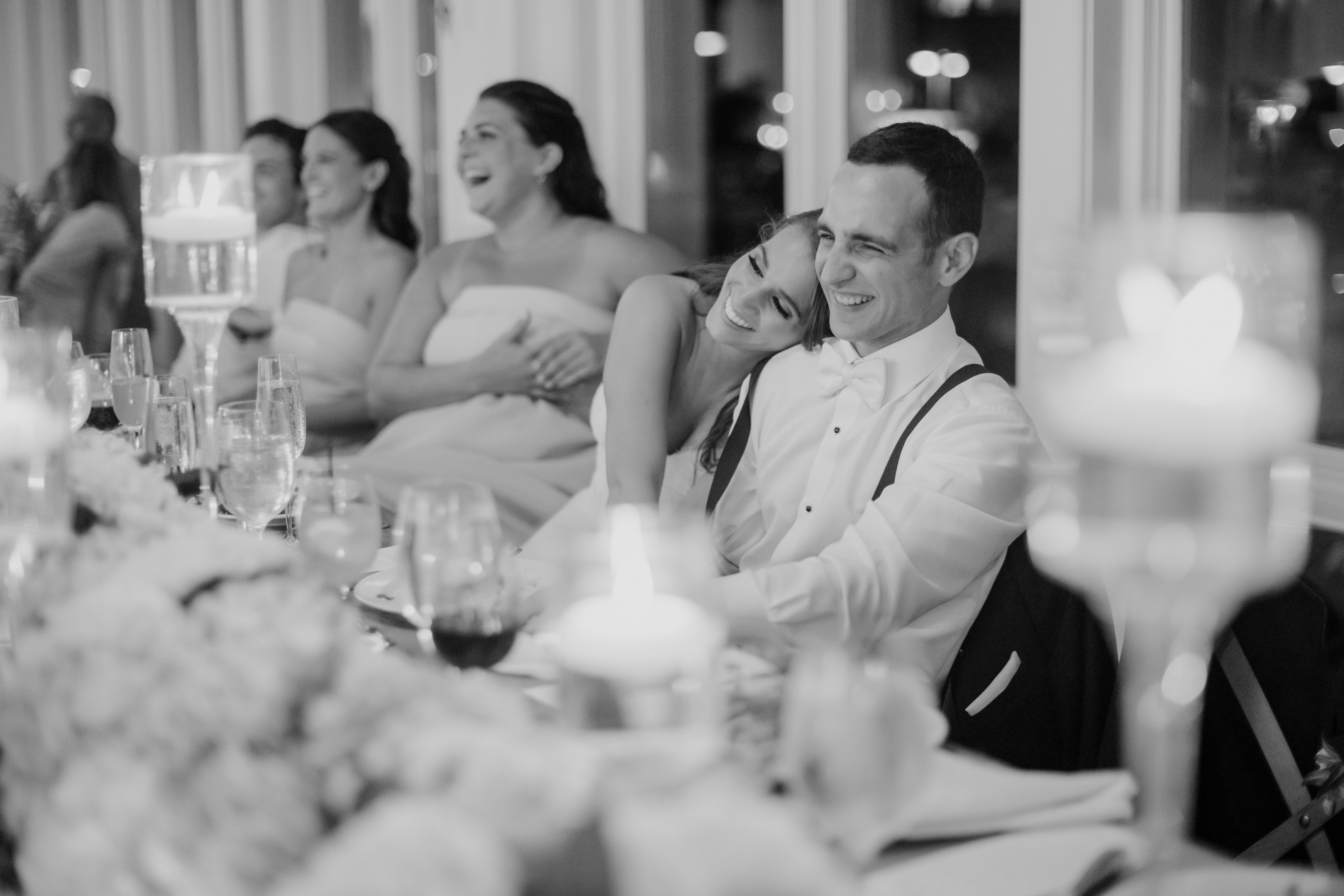 bride and groom share a laugh with their guests during their dreamy north east beach wedding reception
