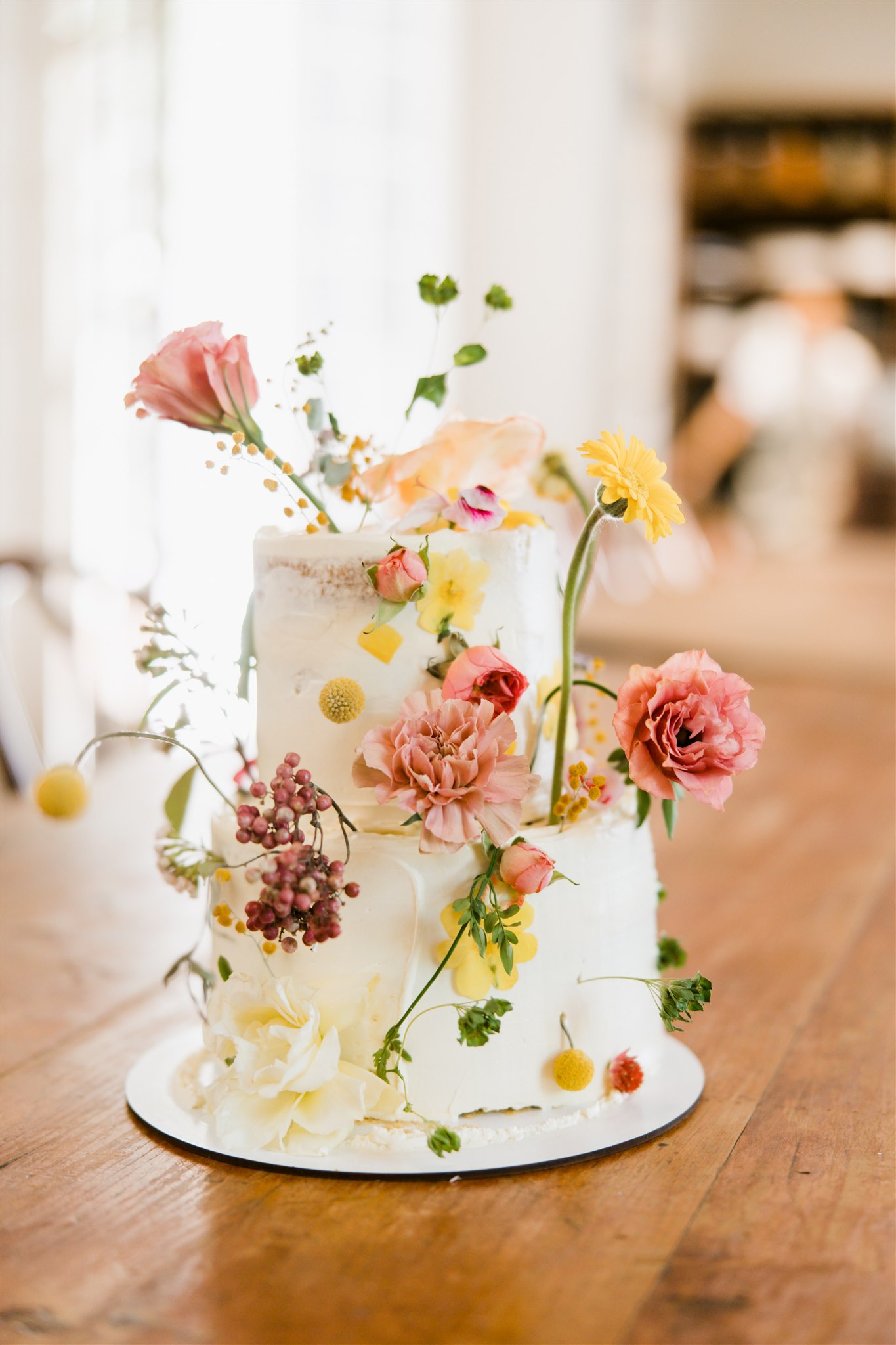 Stunning floral wedding cake waits patiently for its big moment during a dreamy Sobremesa wedding day