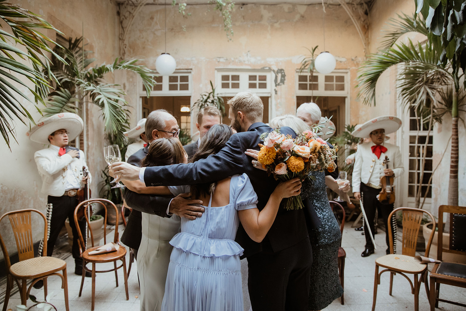 Guests party together and share a group hug during the dreamy Sobremesa wedding