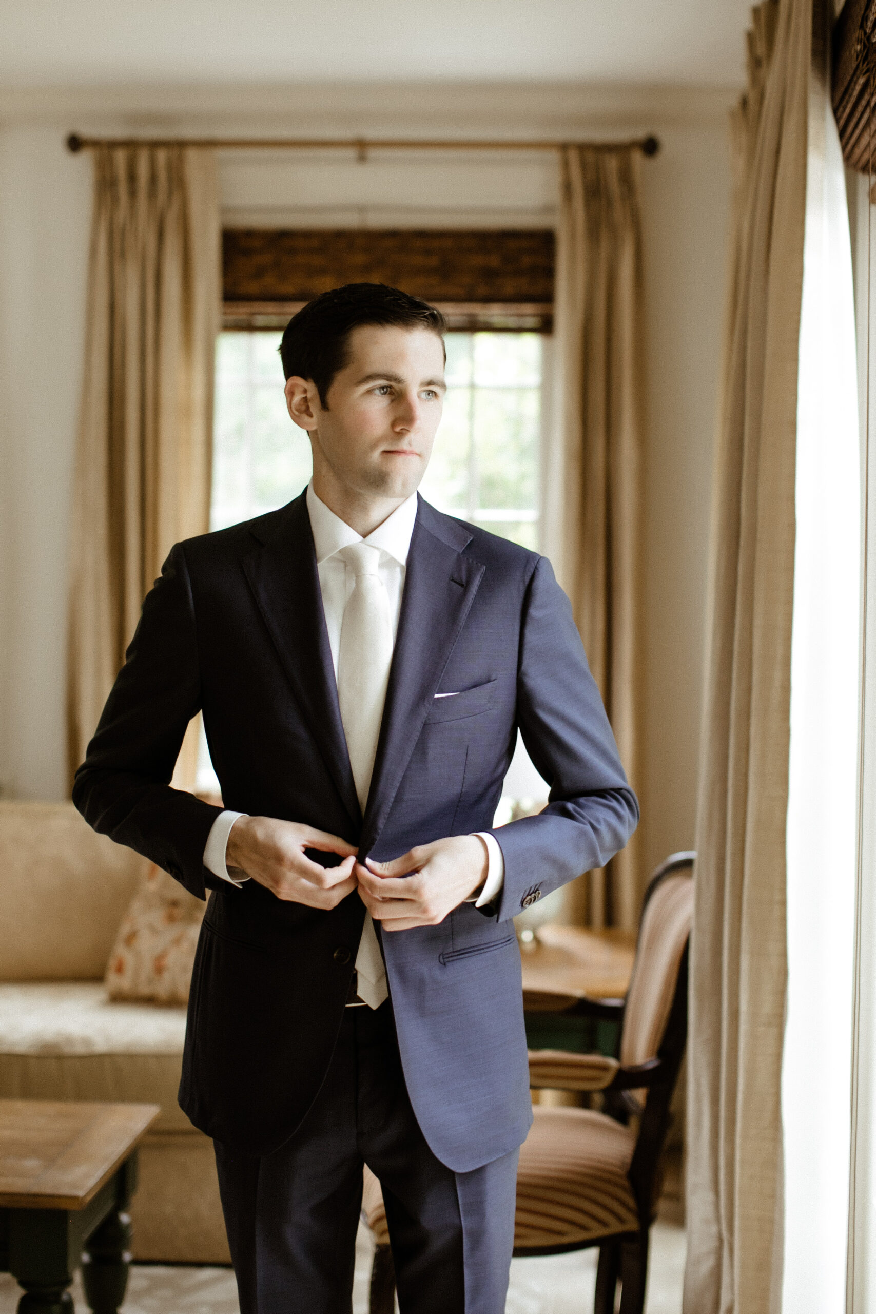 Handsome groom adds final touches as he prepares for he dreamy New York wedding