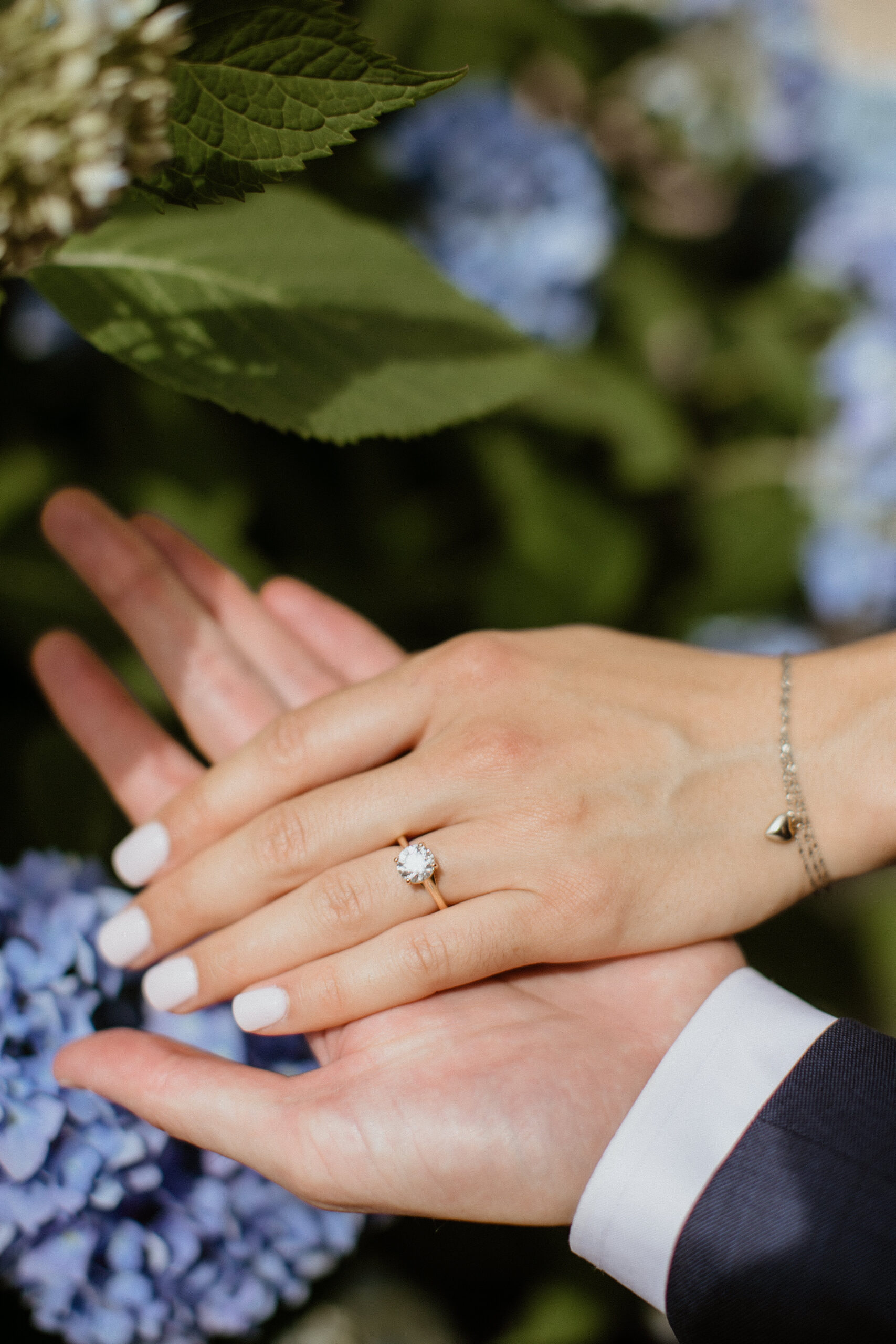 detail shot of the brides wedding ring and the stunning Long Island flowers