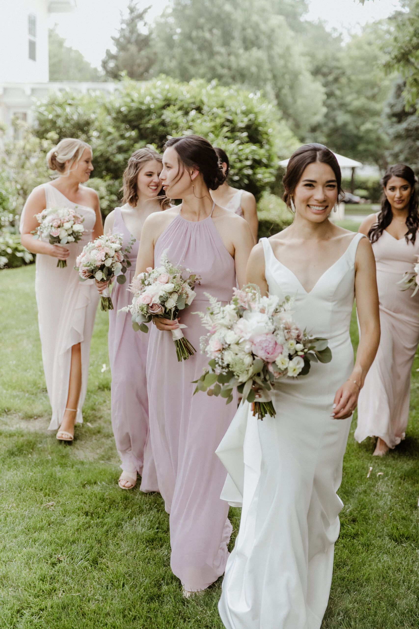 Bridesmaids pose together with their bouquets before the dreamy Long Island wedding