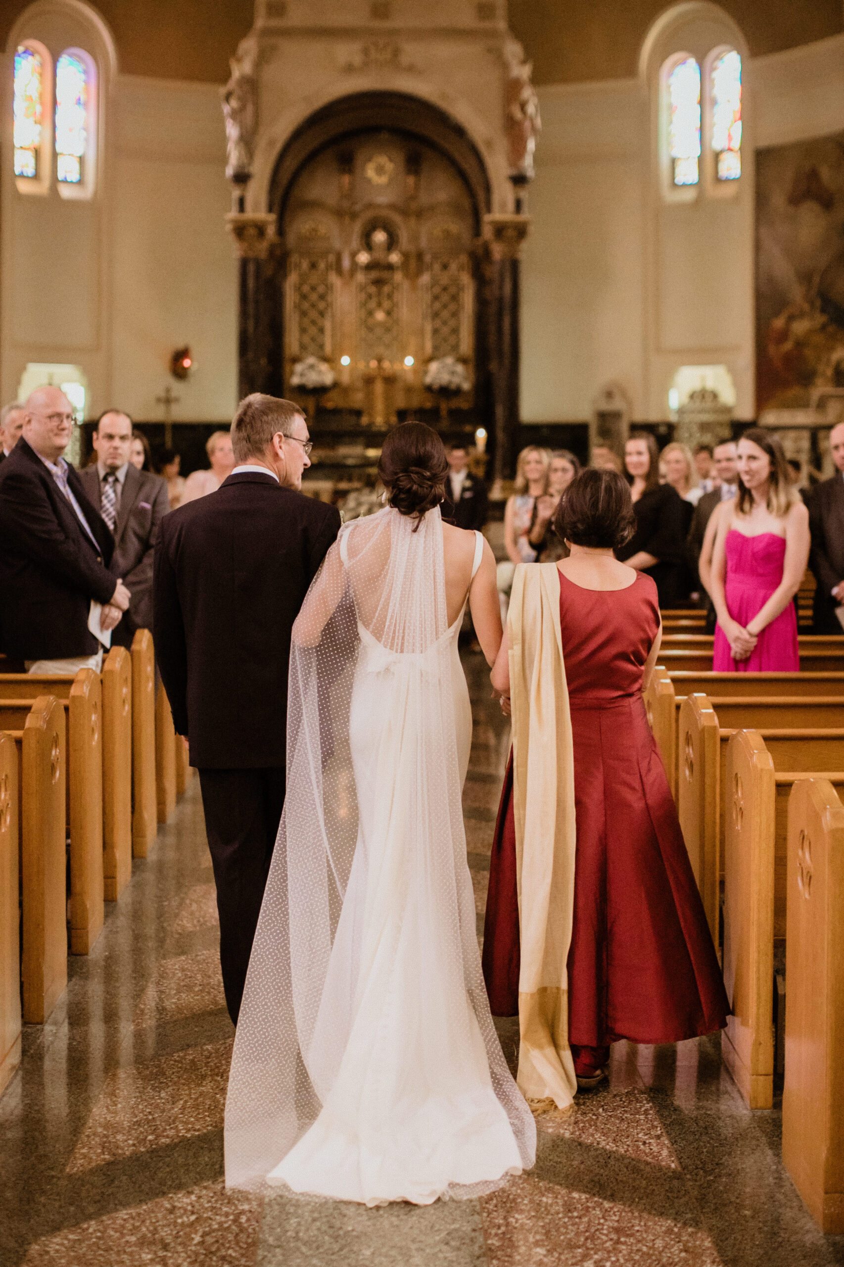 Bride enters and is walked down the aisle by her mother and father