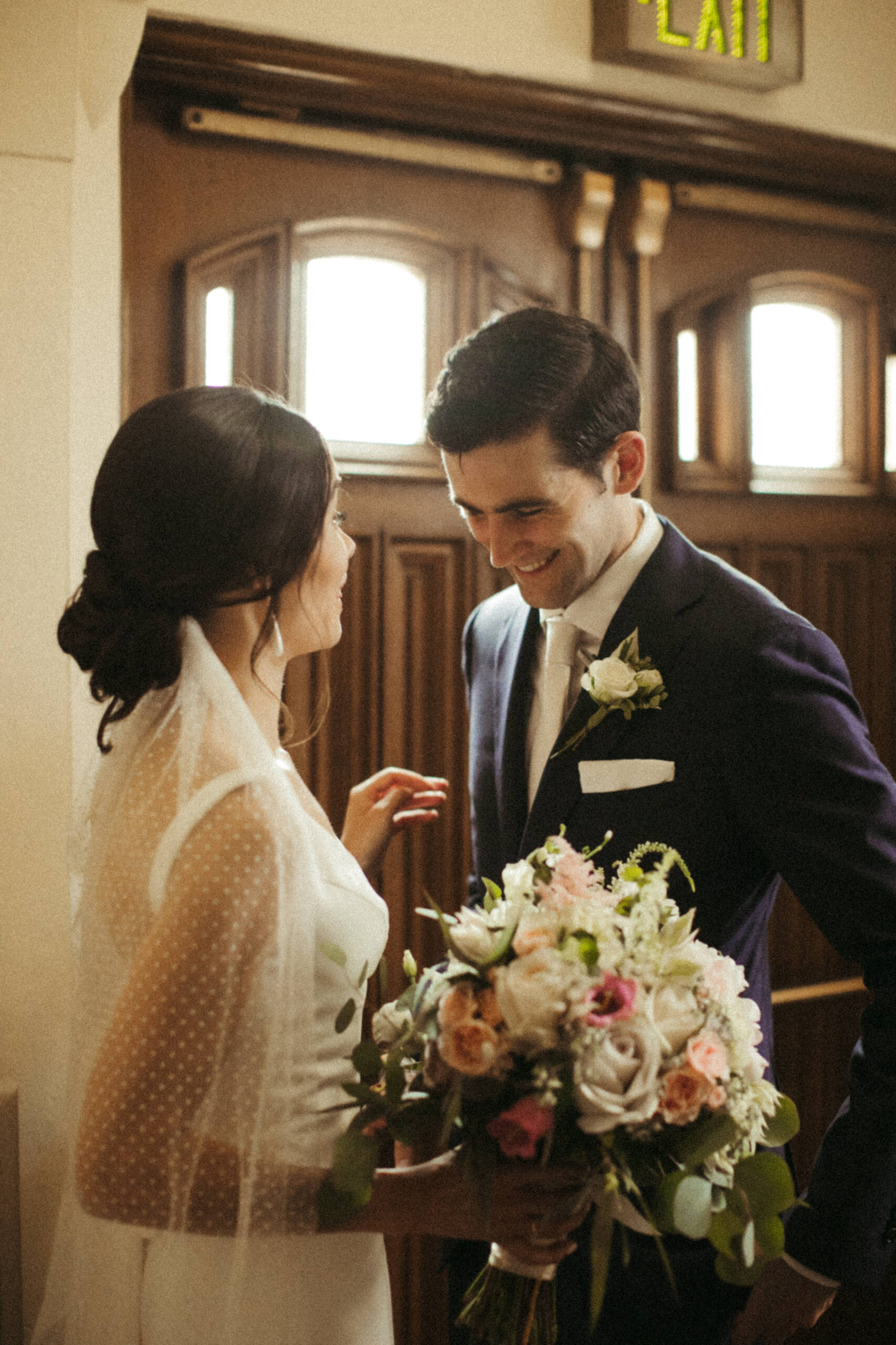 Stunning bride and groom share a laugh as they exit their dreamy Long Island church wedding