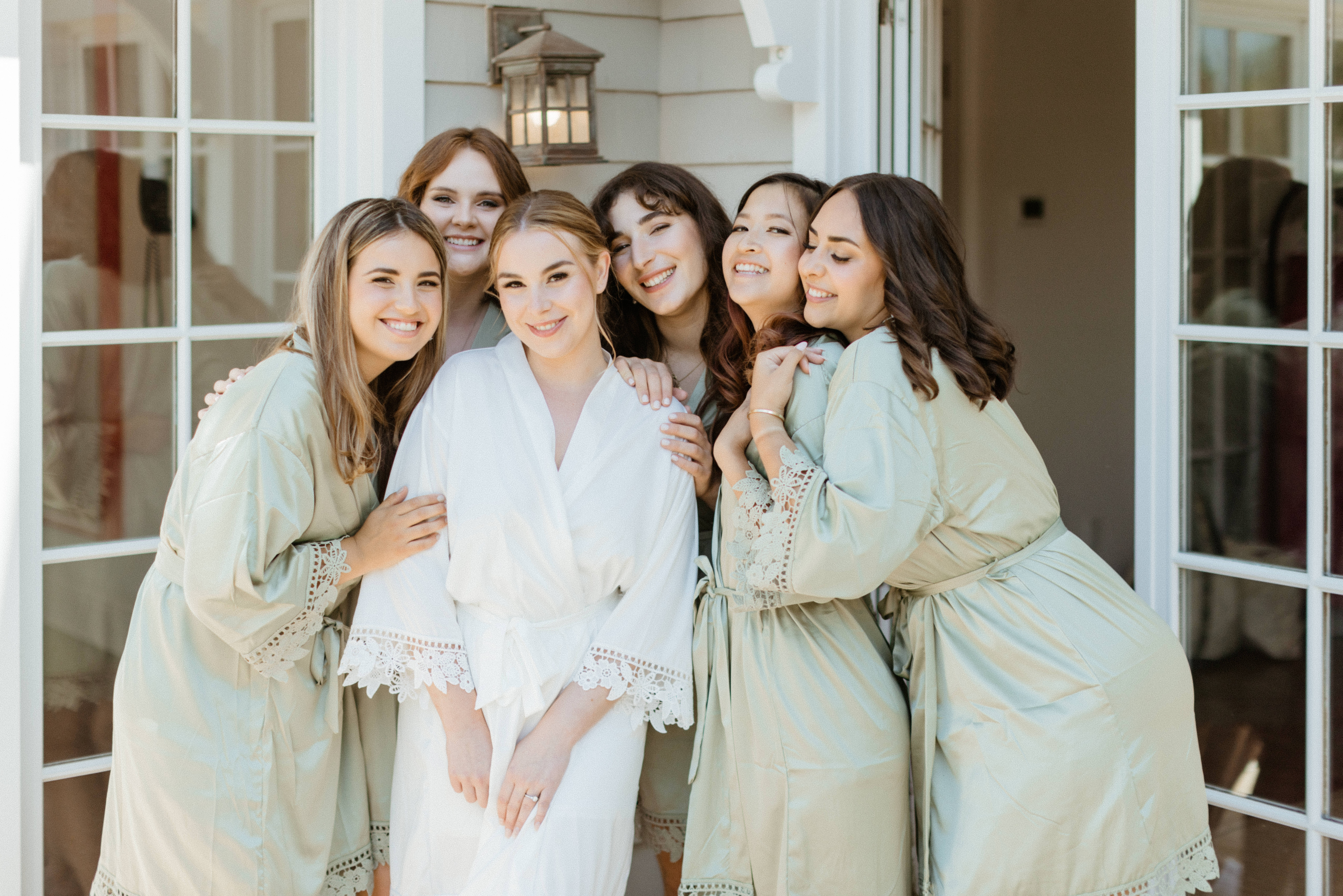 Bride poses with her bridesmaids before her dreamy New York winery wedding