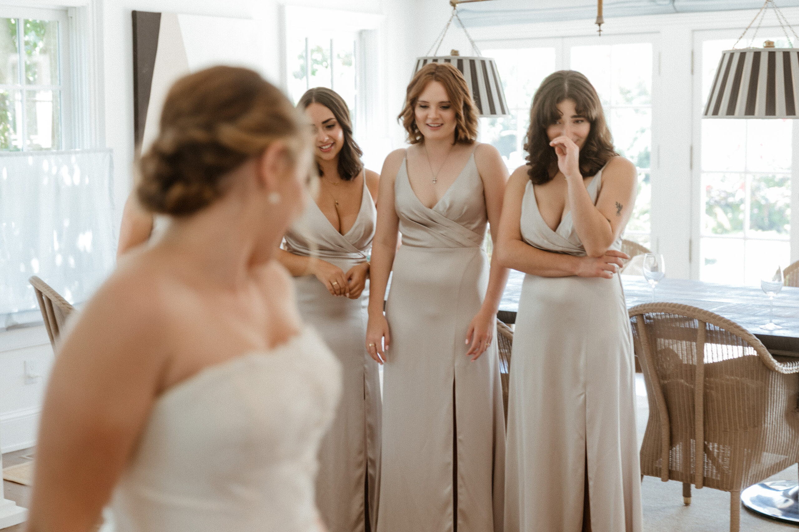 Bridesmaids get a first look at the stunning bride on her dreamy New York winery wedding day