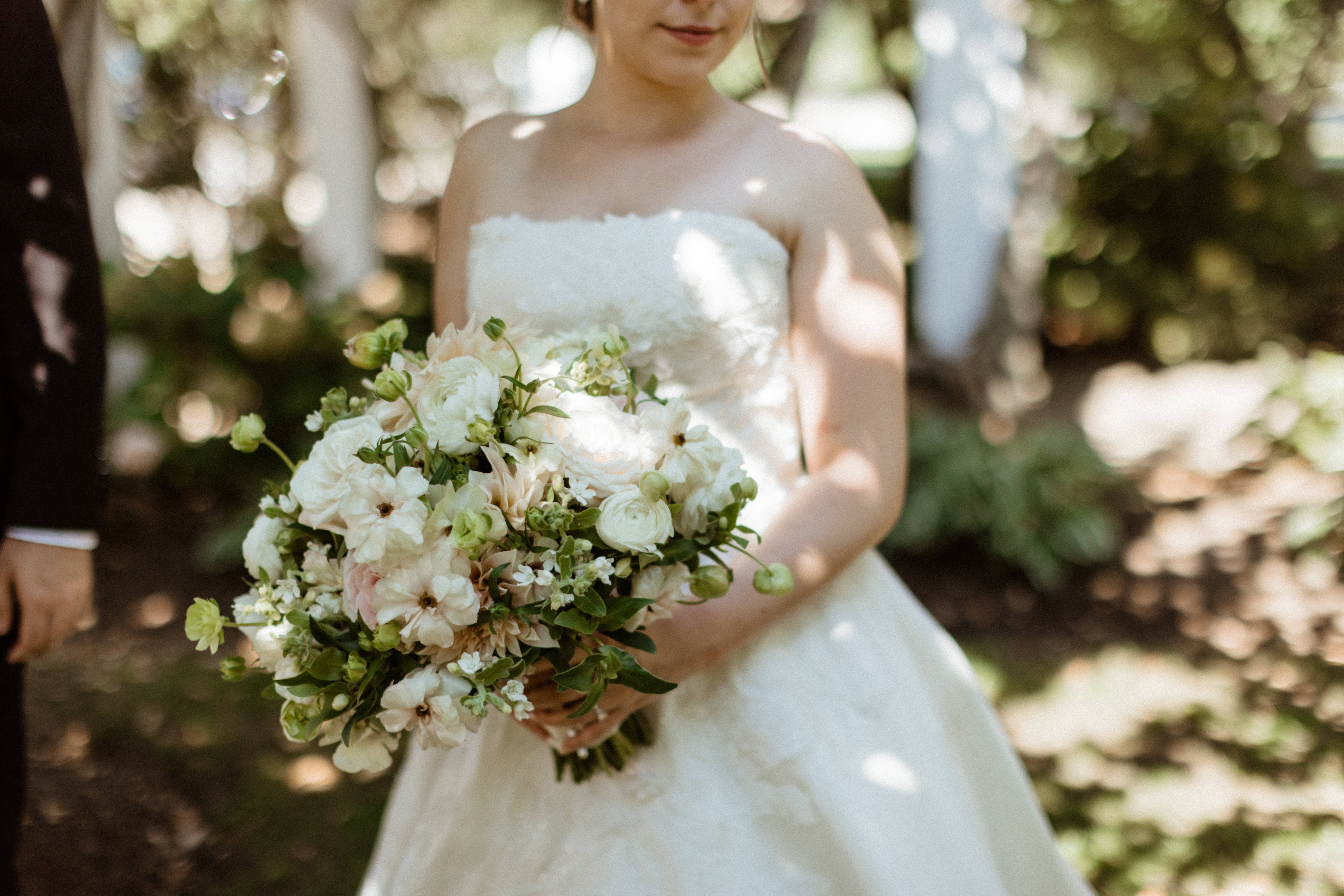 bride poses with her bouquet before her stunning Bedell Winery wedding