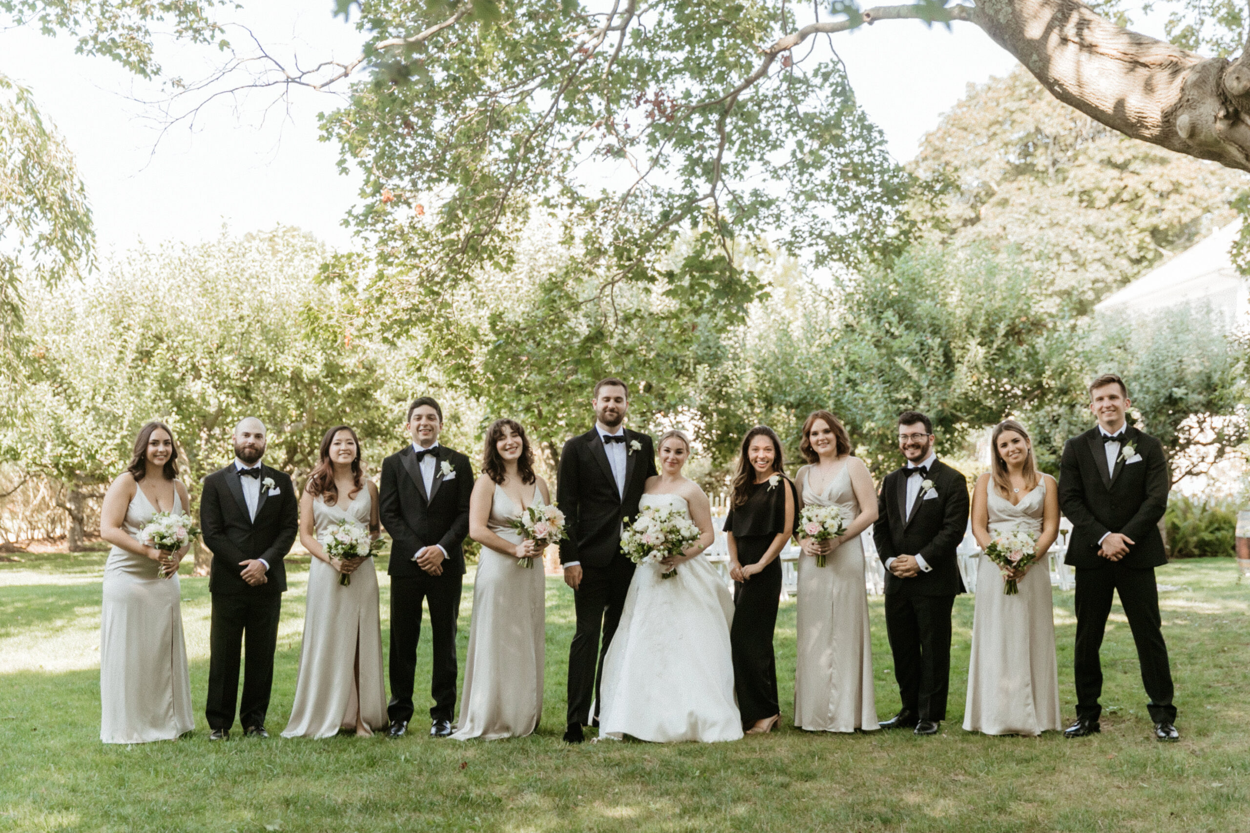 The whole wedding party pose together in the beautiful New York nature