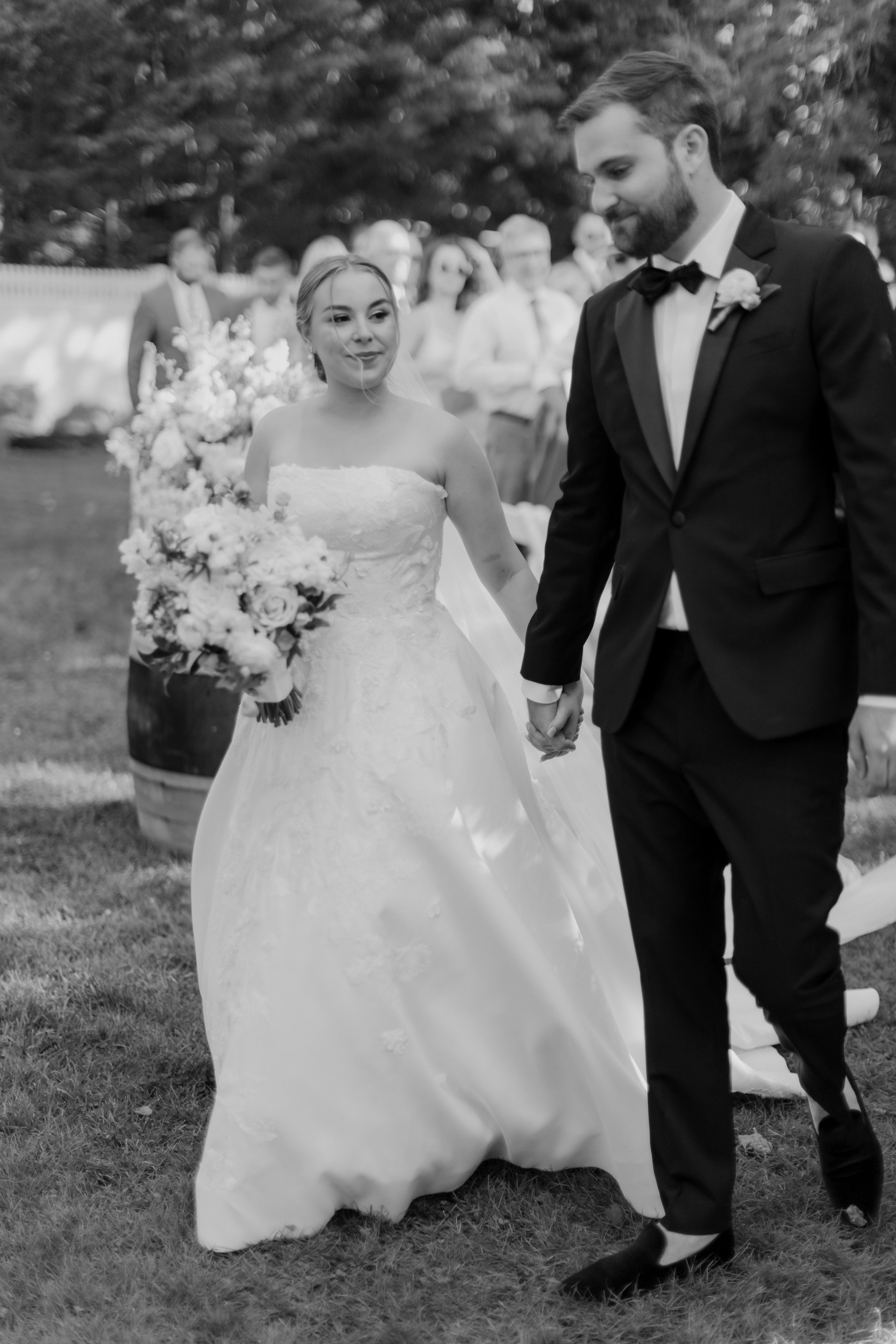 Stunning bride and groom exit together on their dreamy Bedell Winery, New York wedding day