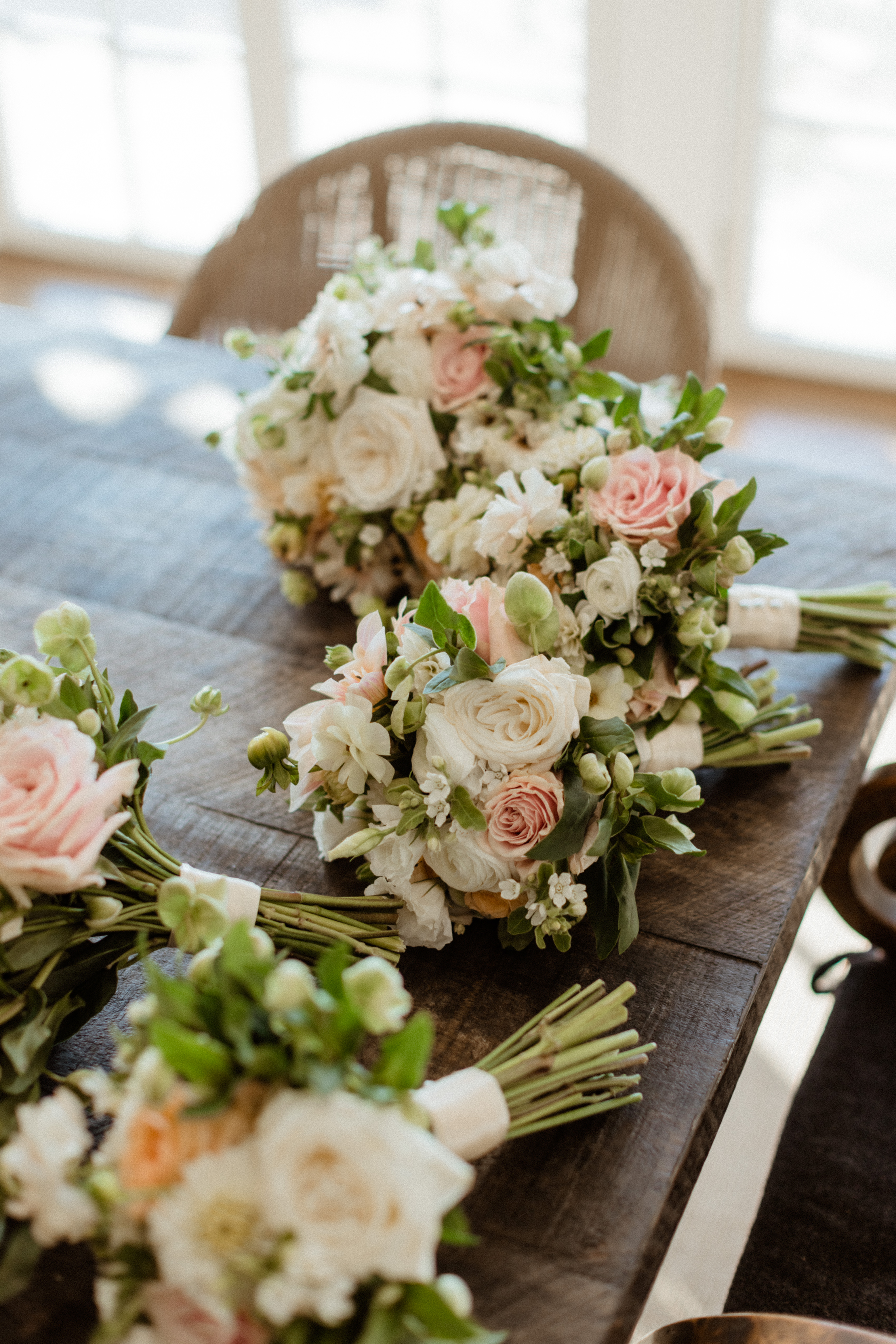 Bride and bridesmaids bouquets lay on the reception table  