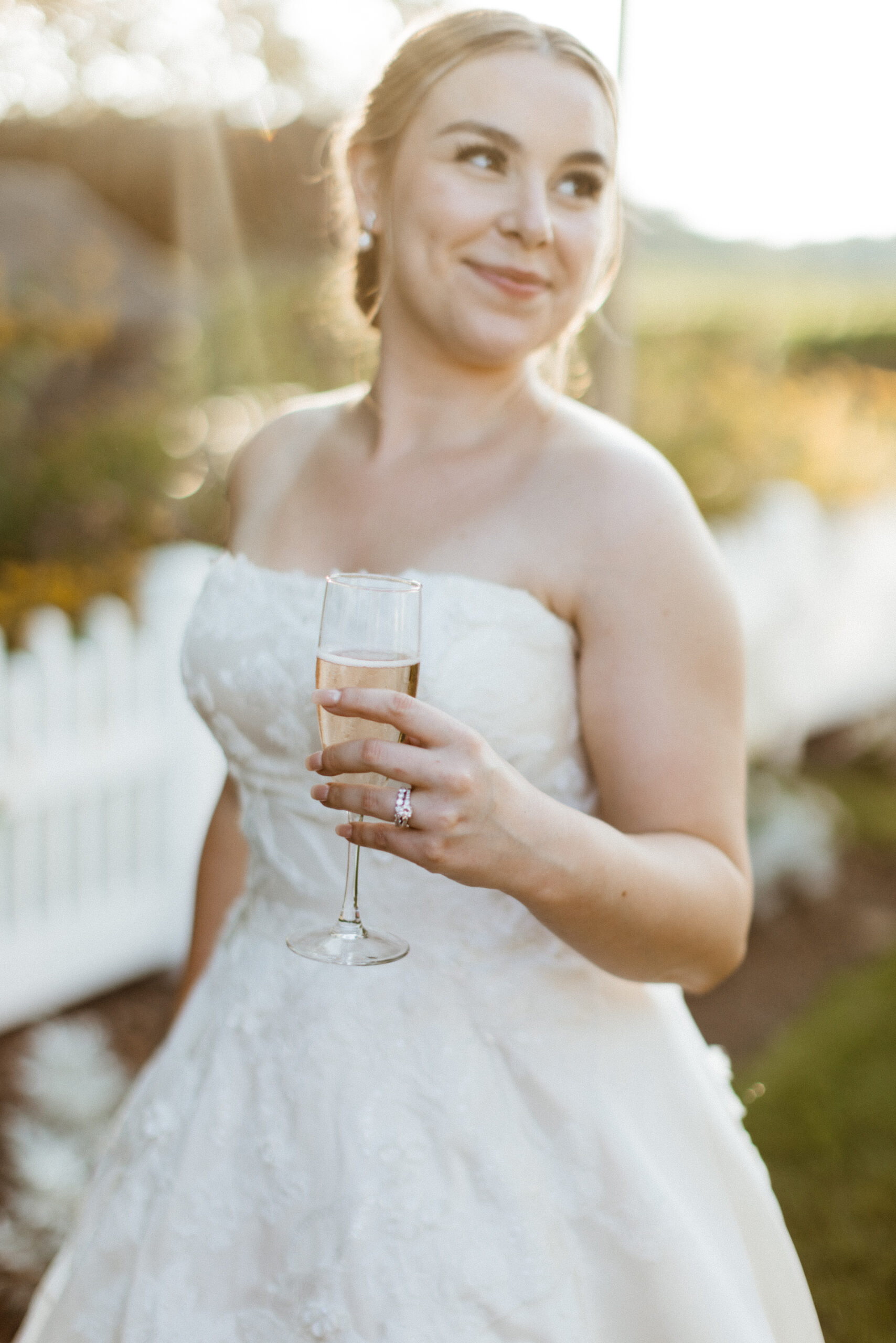 Bride poses with a glass of champagne on her stunning New York wedding day