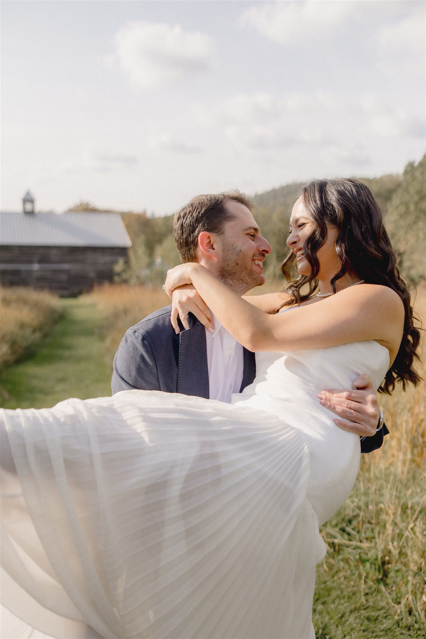 Stunning groom poses with his beautiful bride during their wedding rehearsal dinner photoshoot