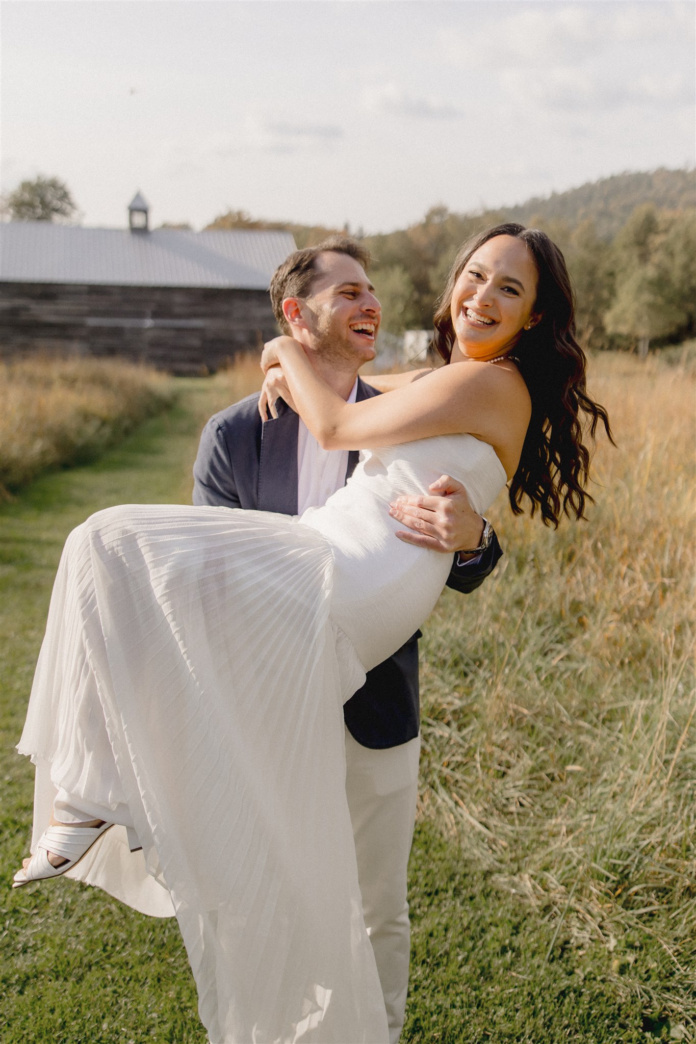 Beautiful husband and bride share a laugh together during their wedding rehearsal photoshoot