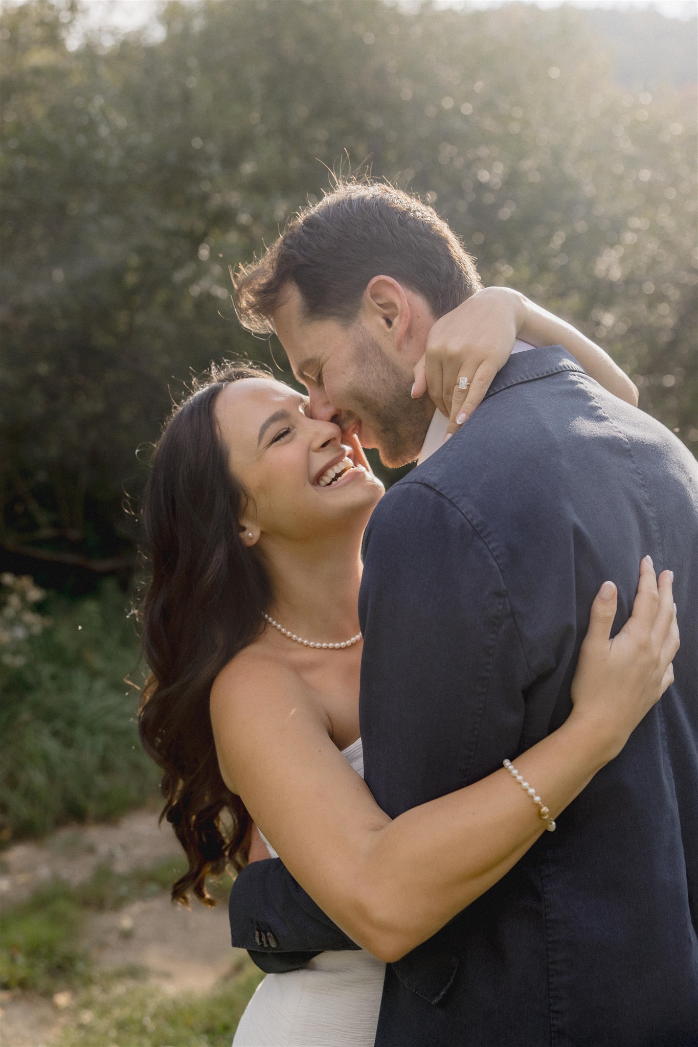Stunning groom poses with his beautiful bride during their wedding rehearsal dinner photoshoot
