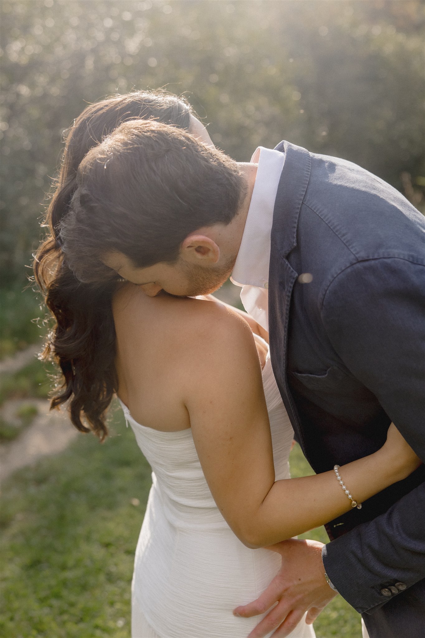 Beautiful husband and bride share a kiss together during their wedding rehearsal photoshoot