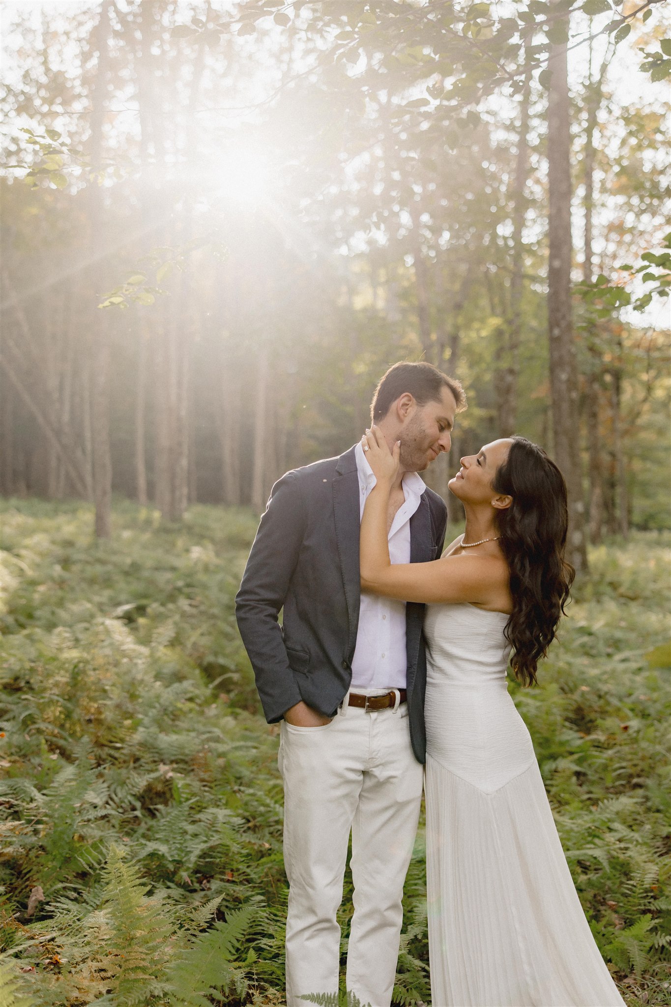Bride and groom pose romantically with the nature in background