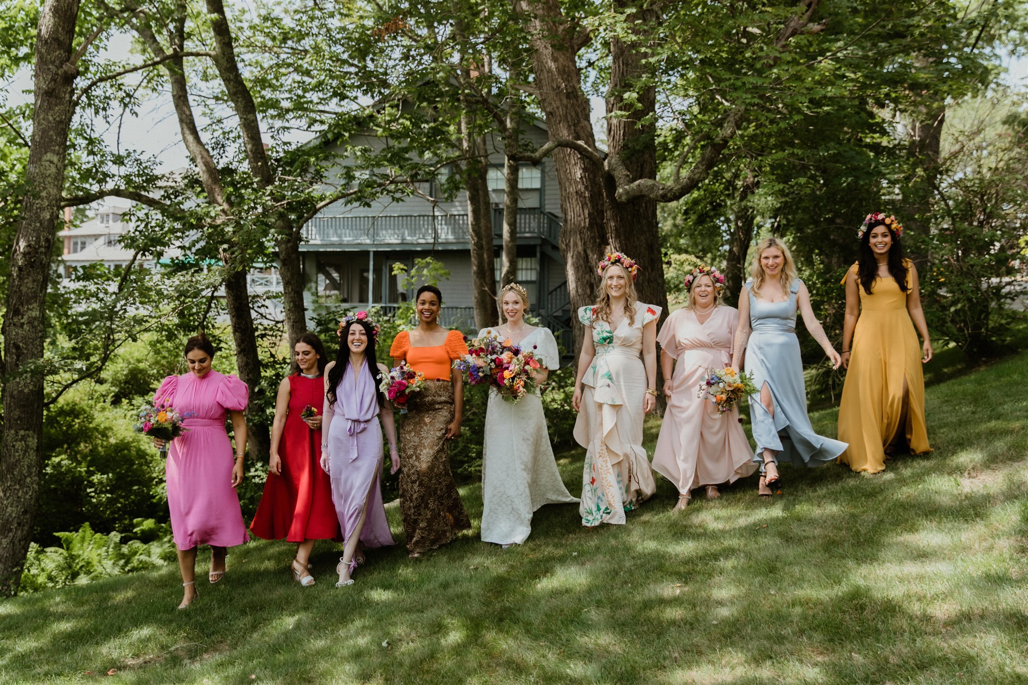 bridesmaids pose with the bride after her dreamy summer Maine wedding