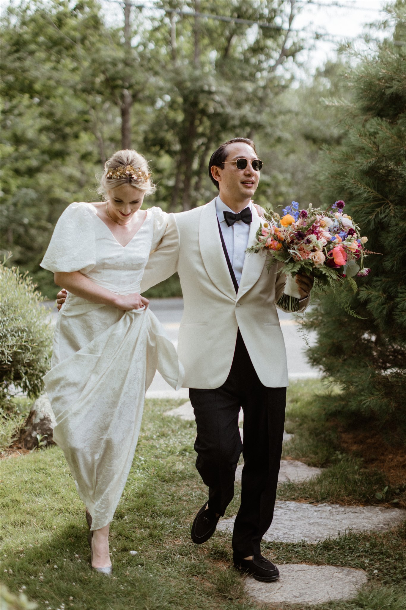 stunning bride and groom walk together after their dreamy summer Maine wedding