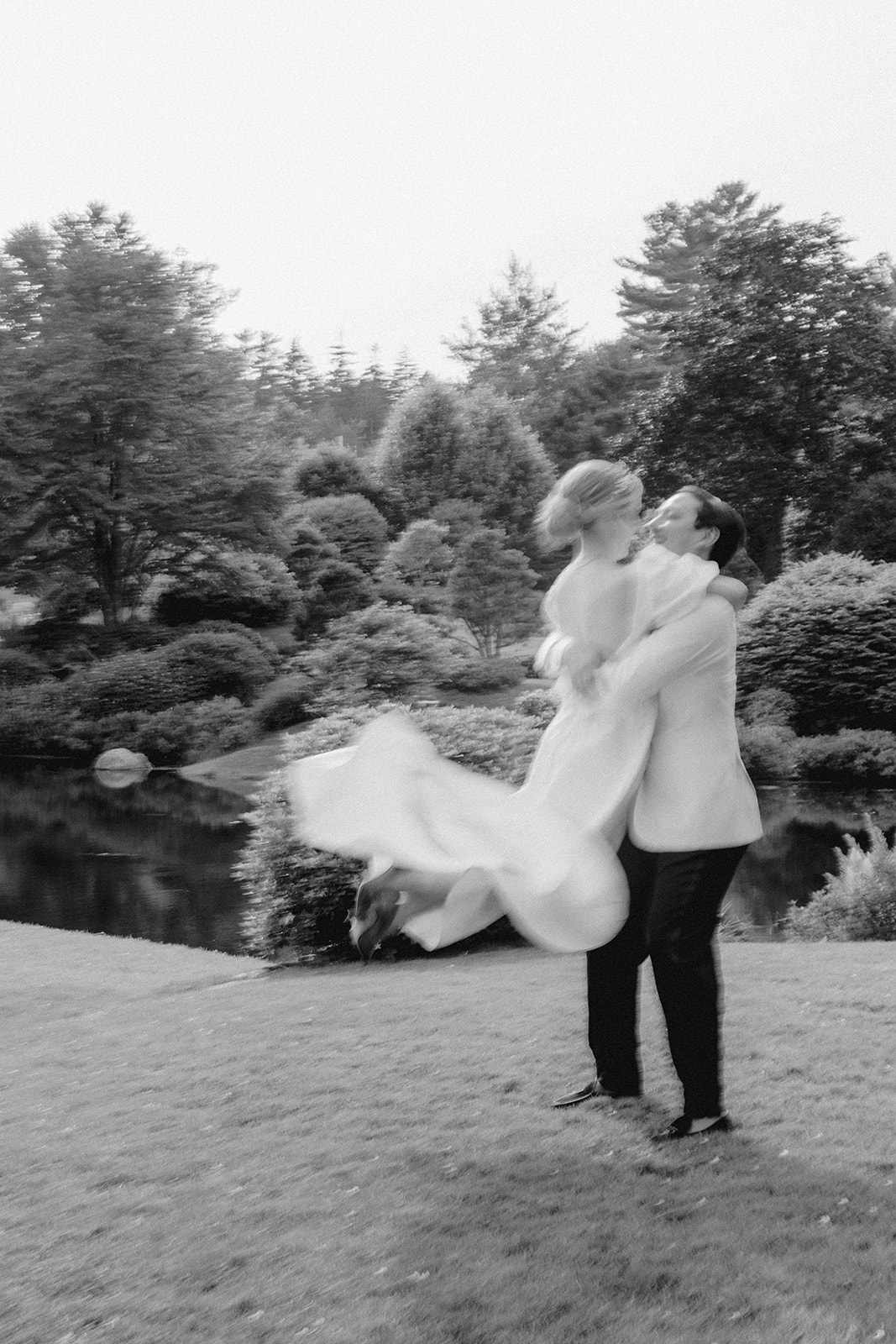stunning bride leaps into her groom arms after their summer Maine wedding