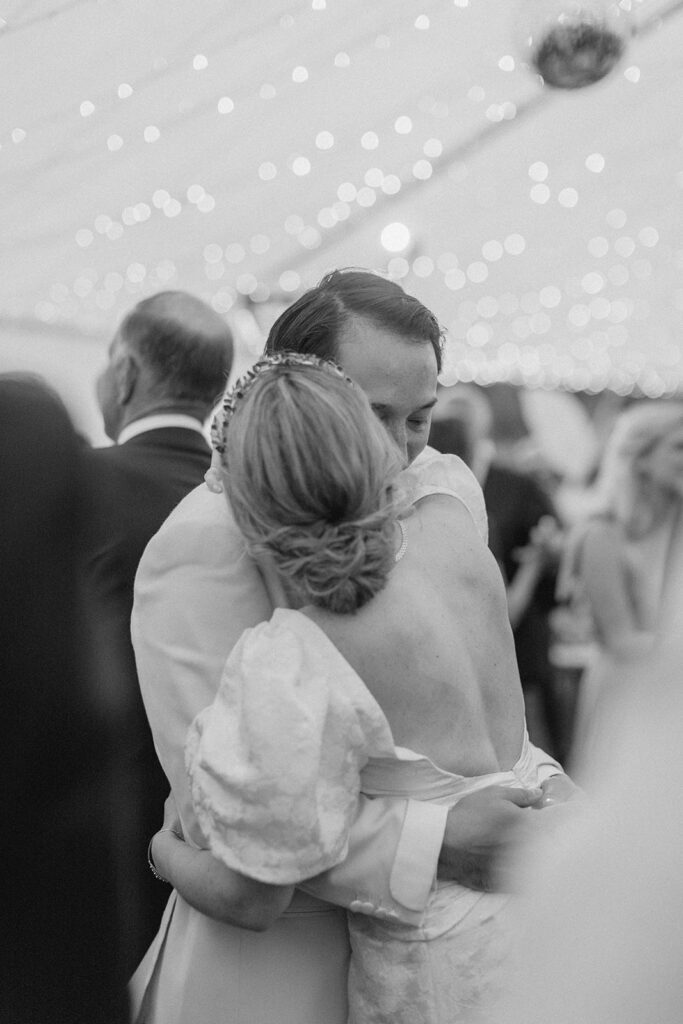 bride and groom dance together during their reception in Maine wedding