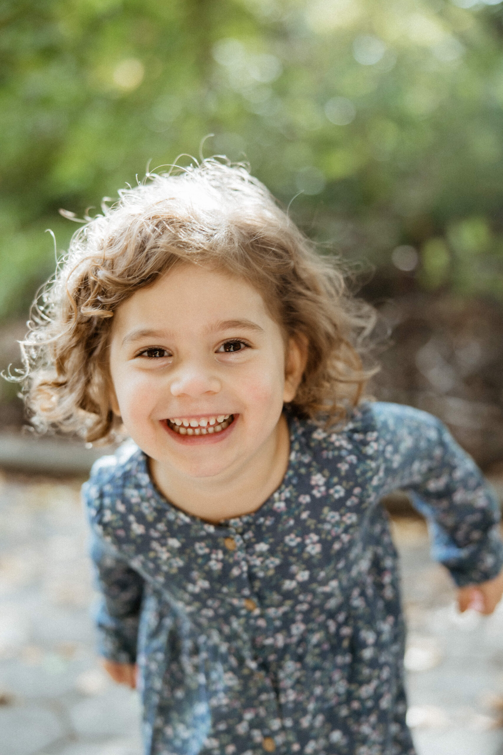 Playful little girl poses for an up close photo during her families NYC family photoshoot