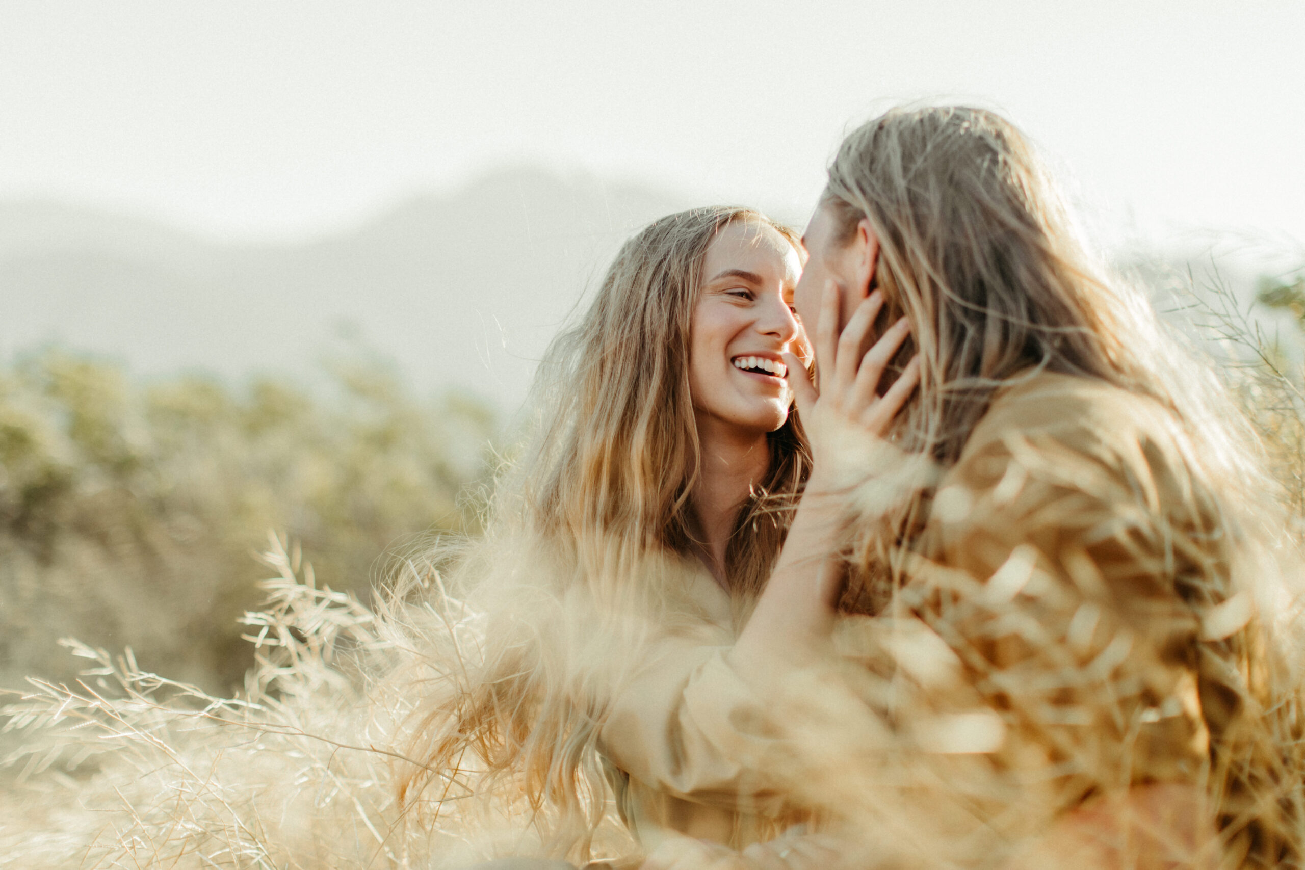beautiful couple pose in a field together during their California engagement photos