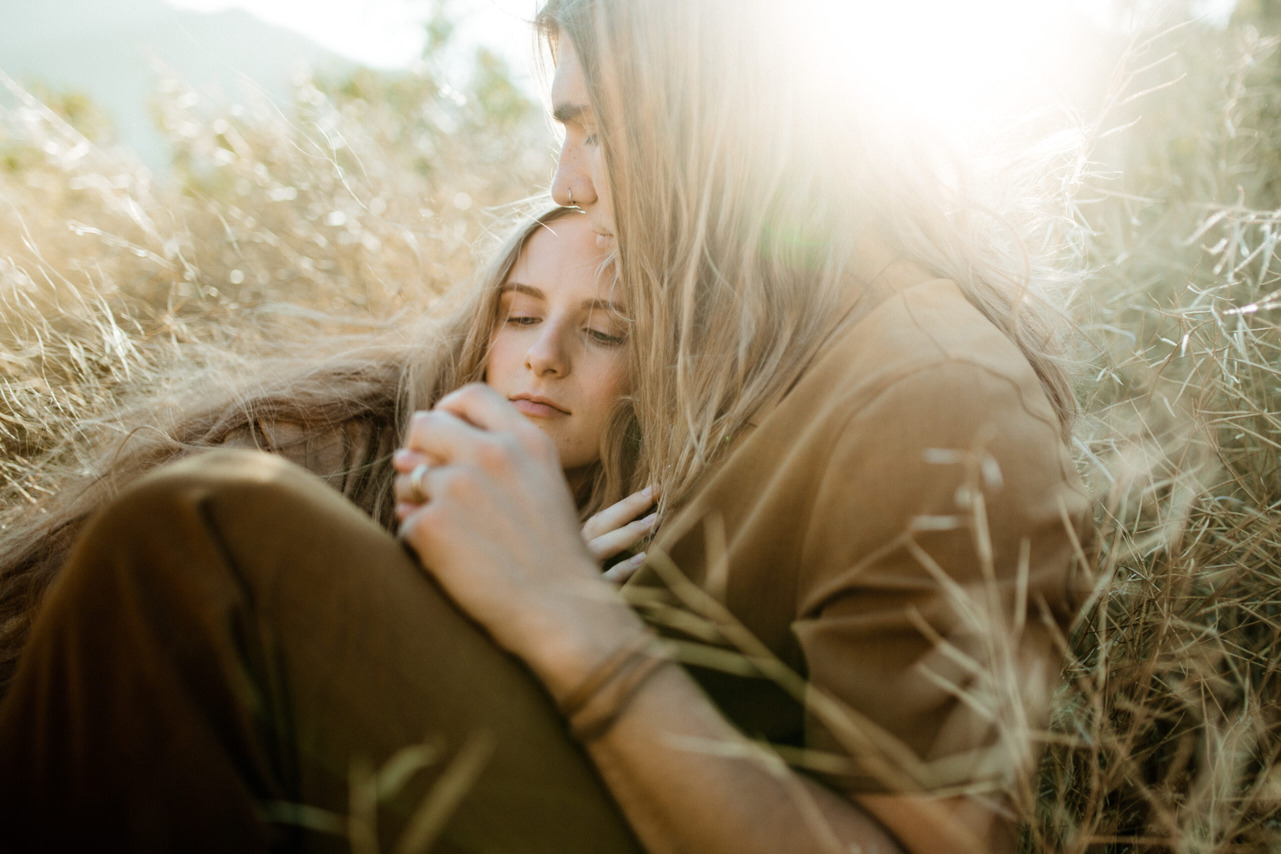 beautiful couple pose in a stunning California field during their engagement photos