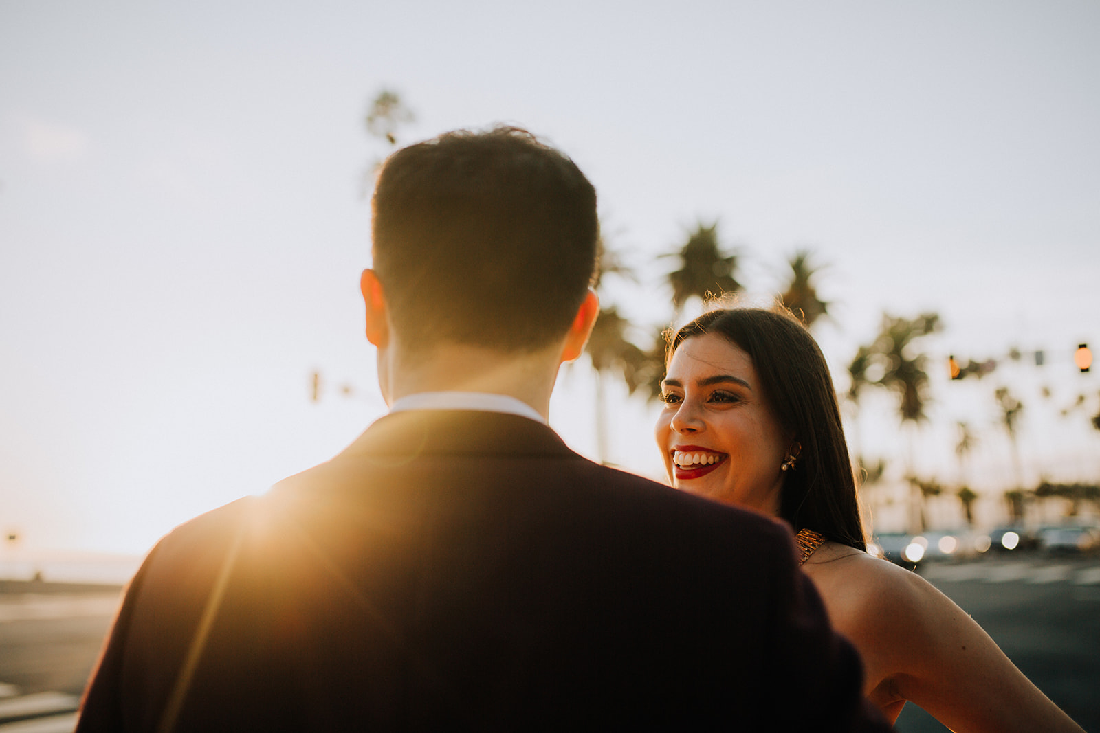 couple pose together with the beautiful sunset in the background during their dreamy wedding rehearsal photography