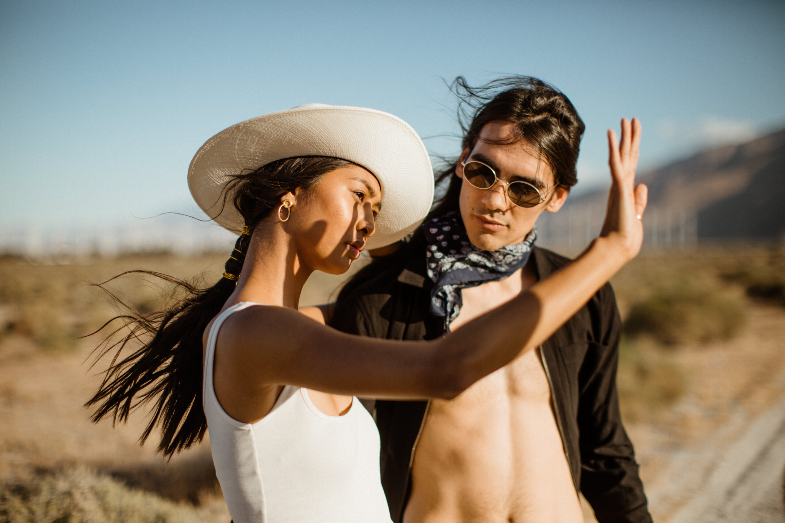 couple pose during their romanticism desert engagement photoshoot