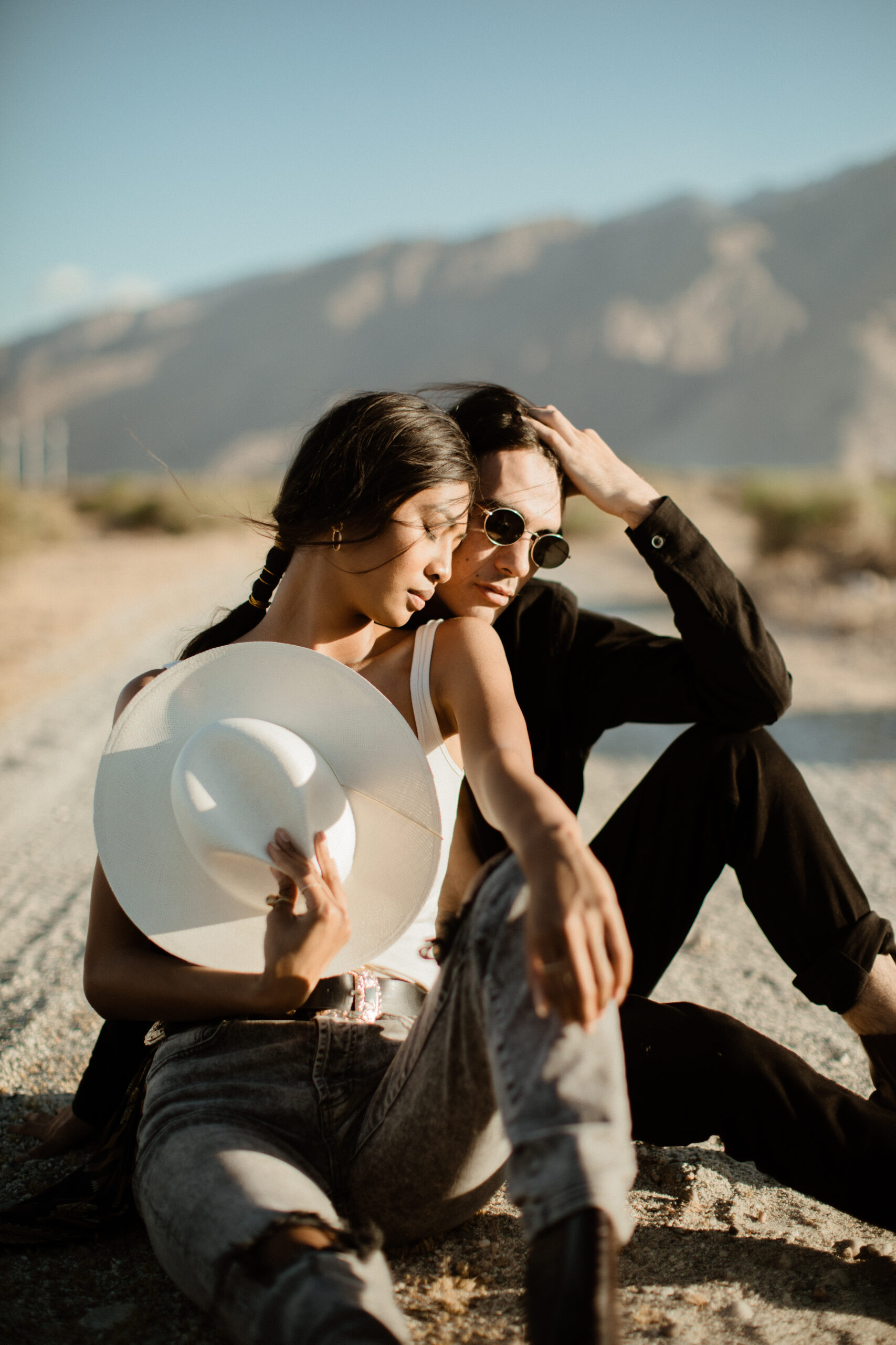couple pose during their romanticism desert engagement photoshoot