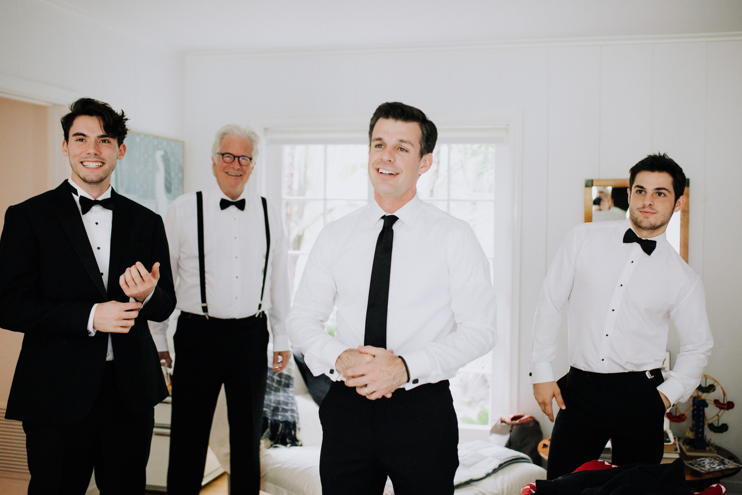 groom poses with his groomsmen