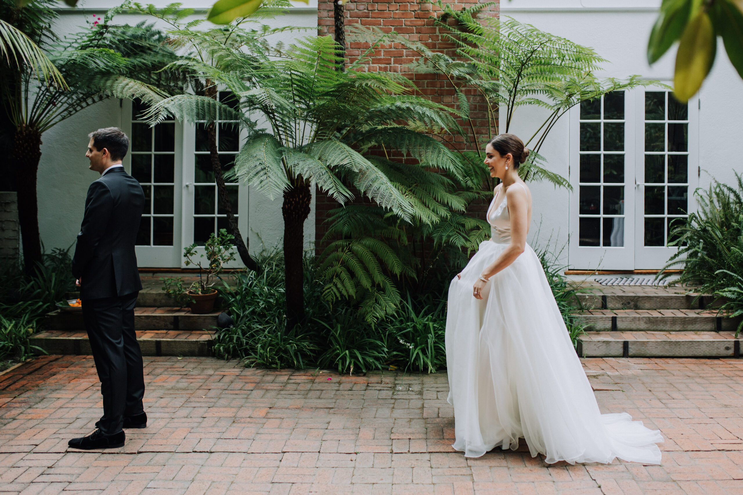 bride and groom share candid emotions during their lush garden Los Angeles first look wedding photos 