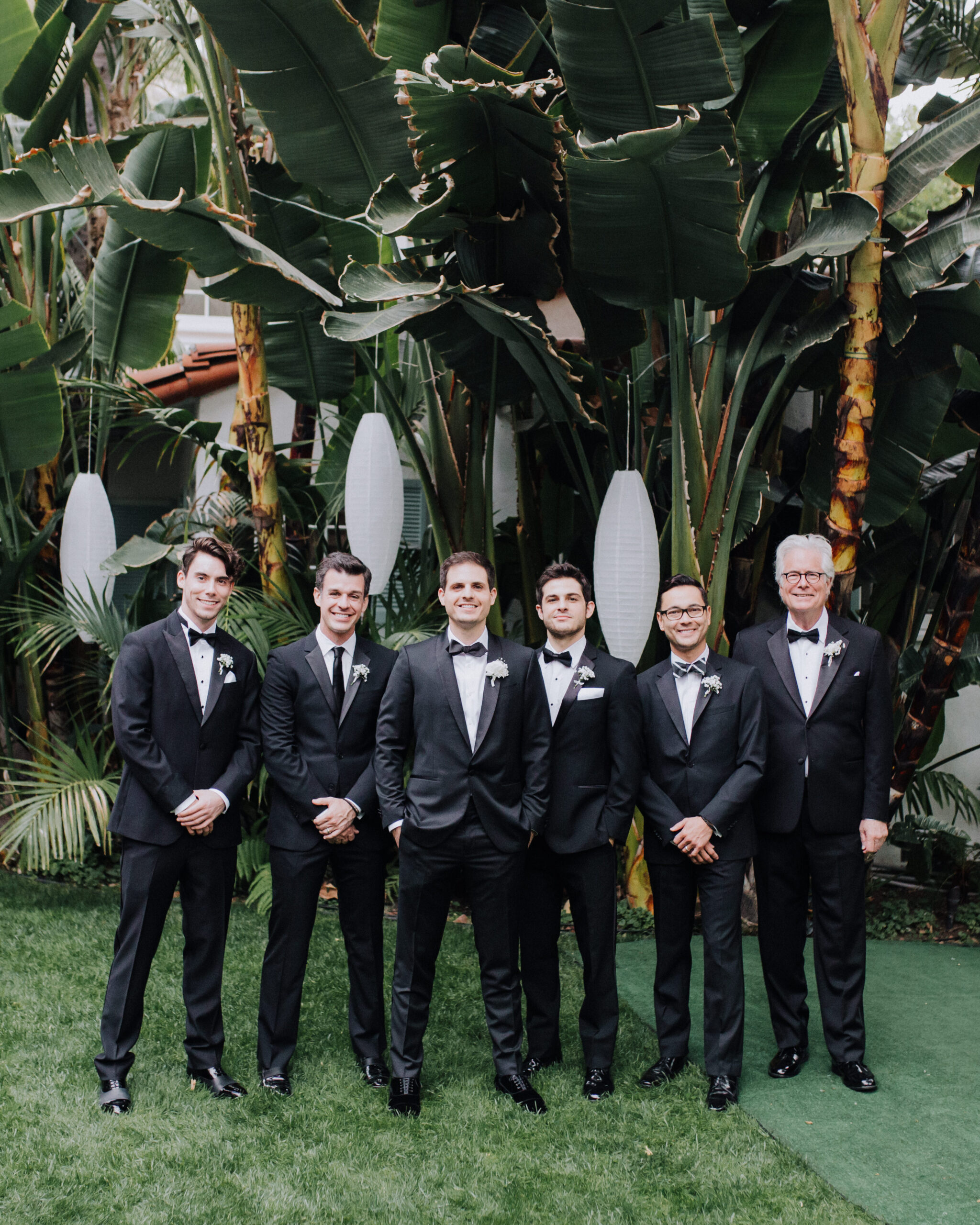 groom poses with groomsmen before his Los Angeles garden wedding