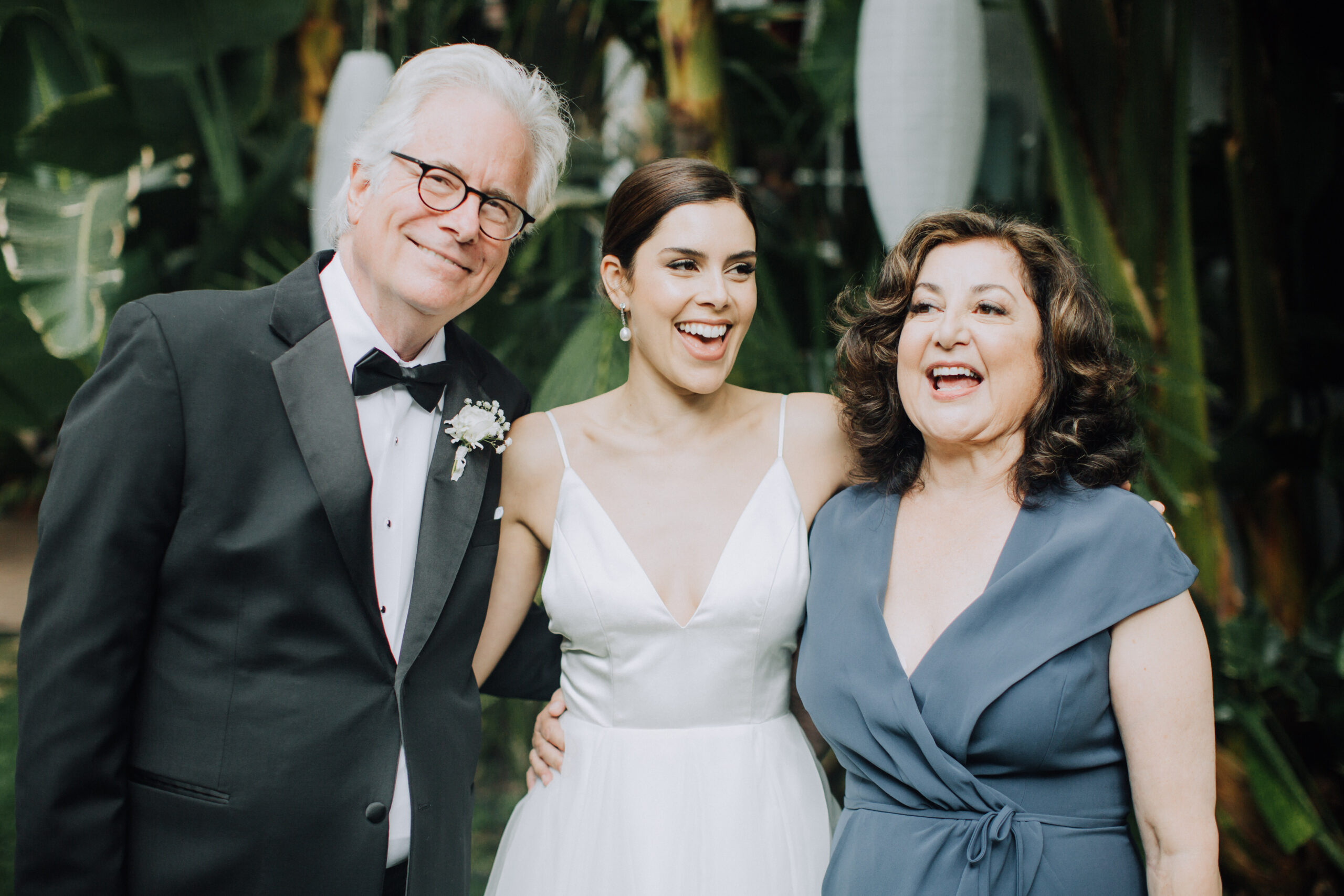 bride poses with her mom and dad before her dreamy backyard garden wedding ceremony in Los Angeles