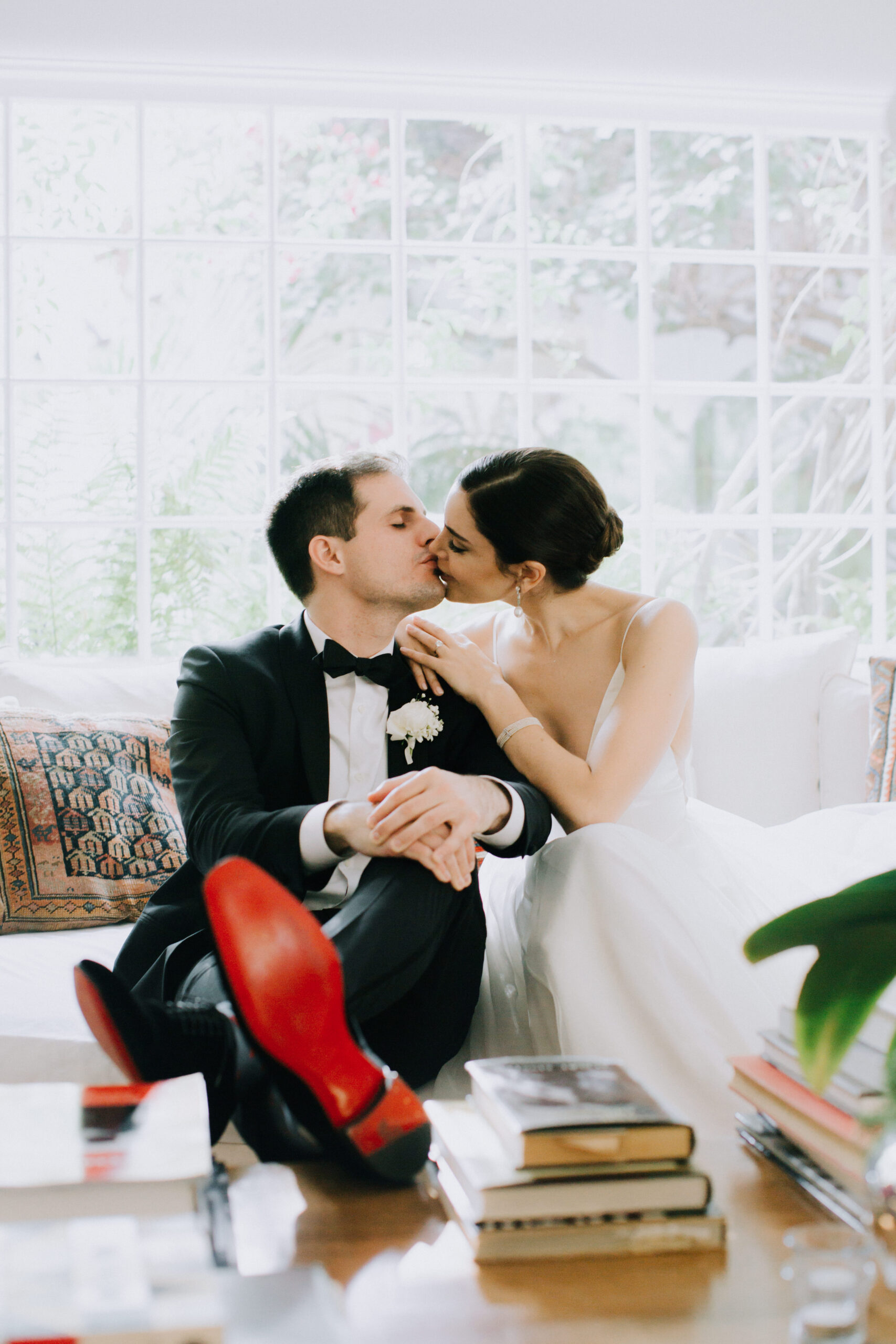 bride and groom share a kiss before their dreamy backyard wedding ceremony